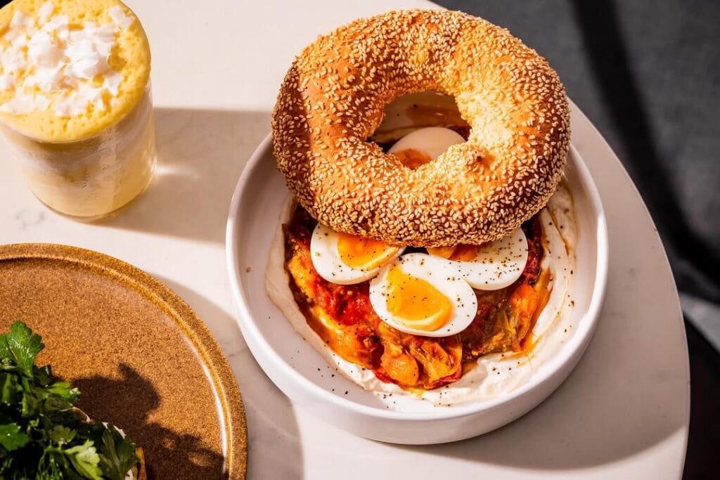 A bagel with boiled eggs inside atop a table at HAM in Cronulla. 
