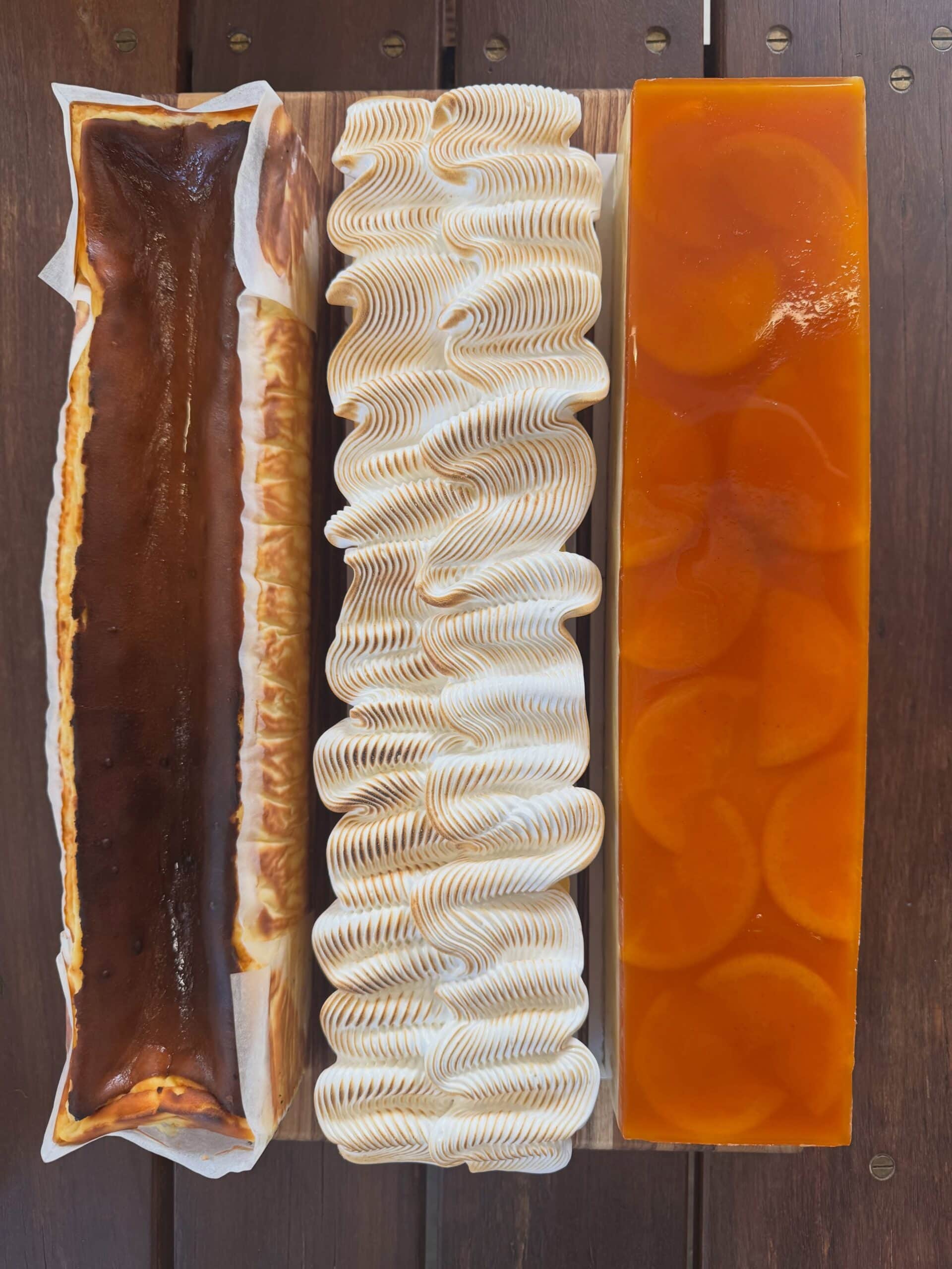 Three long-form cheesecakes from Lulu & Me in Collingwood, including Basque, toasted meringue and fruit-topped varieties.