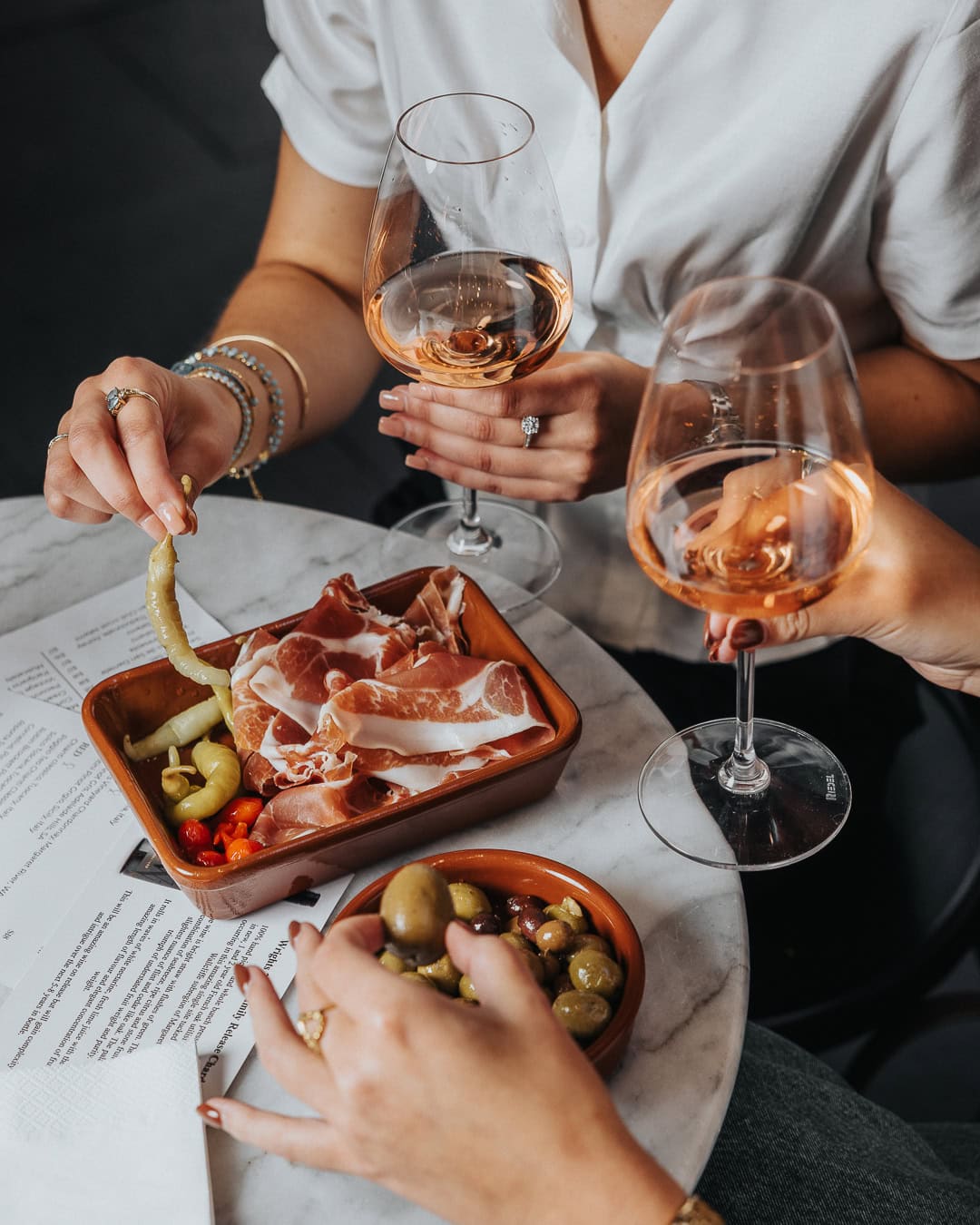 Prosciutto, olives and rosé wine on marble table at I Love Florence Sydney CBD