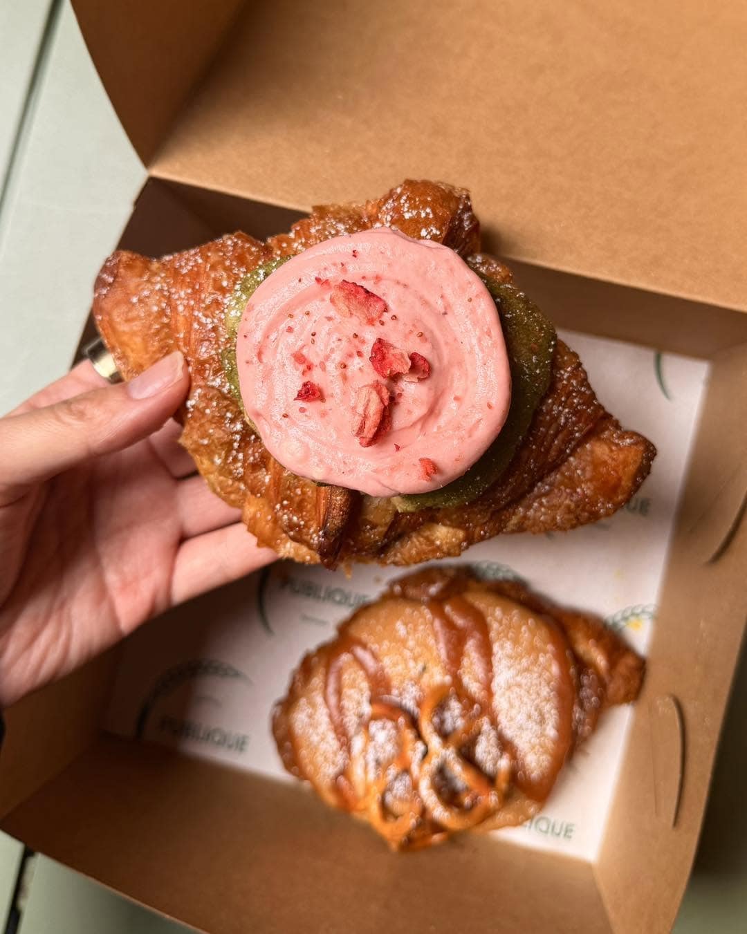 Strawberry cream pastry and kouign-amann in a bakery box from Publique Bakery.
