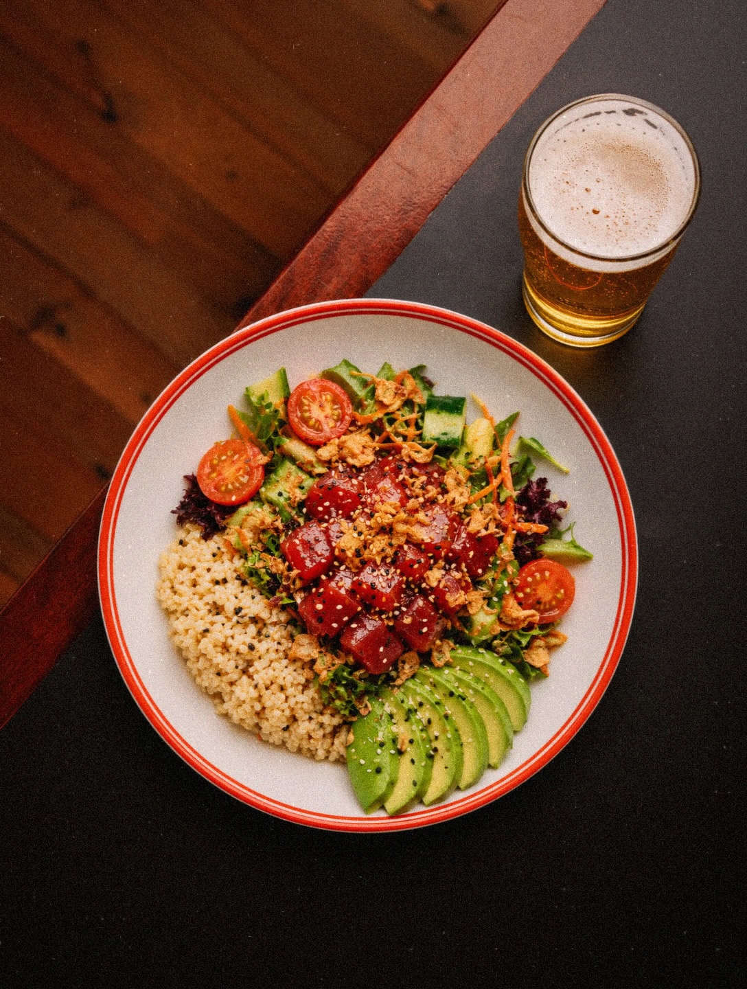 Tuna poke bowl with pearl couscous, avocado and salad beside a lager at Capital Brewing Co.'s Lager House, Campbell Canberra
