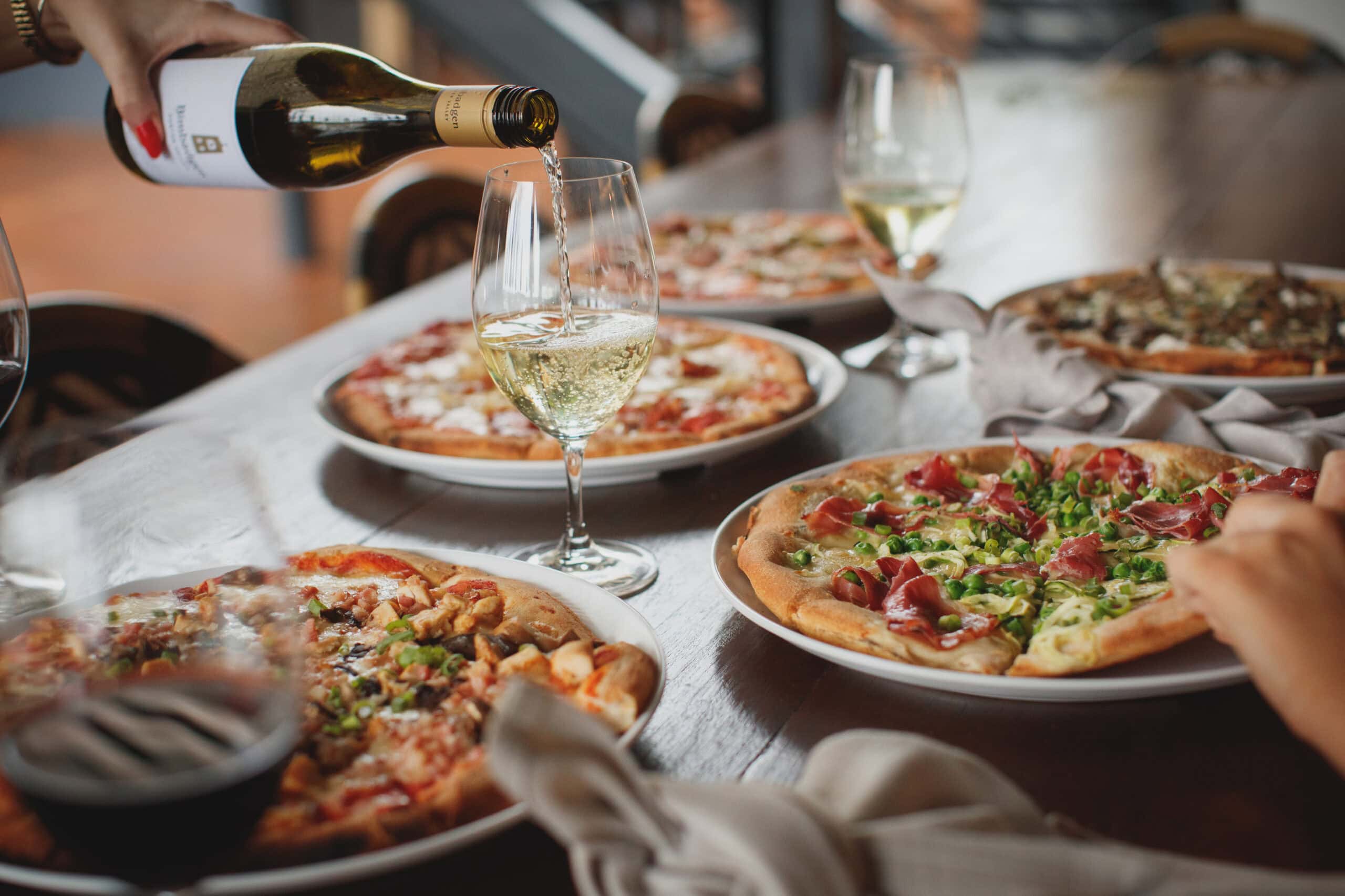 Woodfired pizzas and white wine being poured at Bimbadgen pizzeria Pokolbin Hunter Valley
