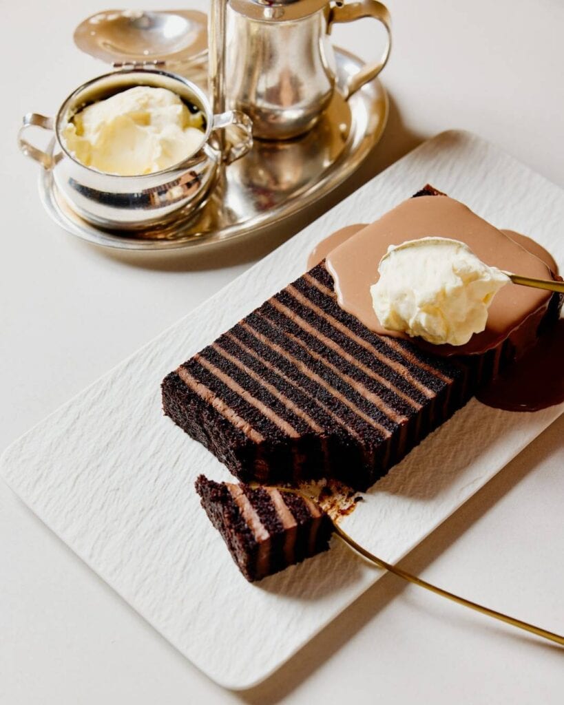 32 layer chocolate cake sliced with whipped cream and silver service The Fullerton Hotel Sydney CBD