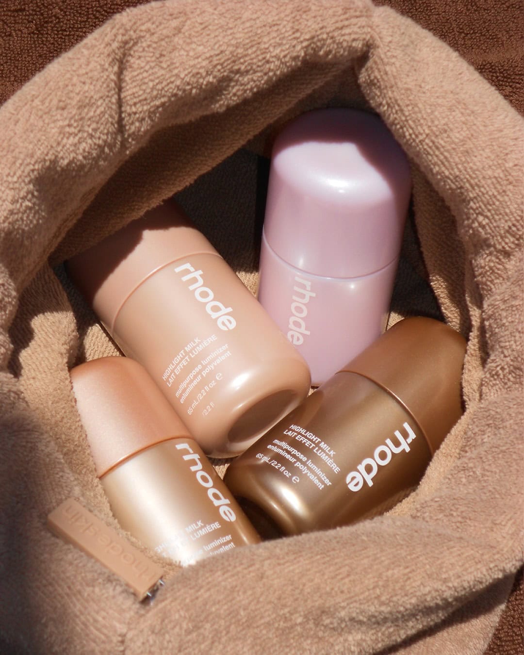 The four shade shimmering glazing milk from rhode's 2026 summer collection.