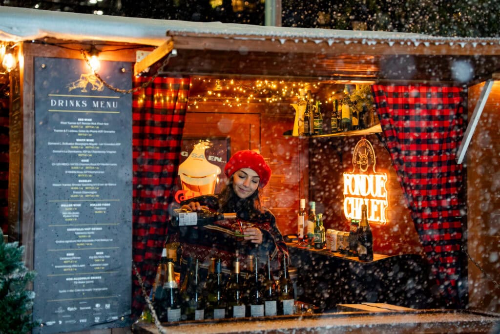 Fondue Chalet Melbourne woman pouring wine in chalet 