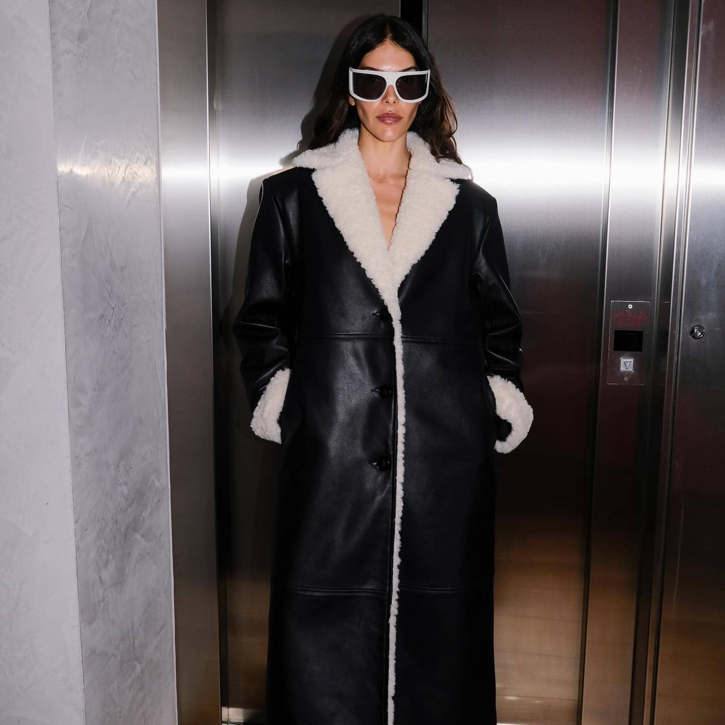 Ena Pelly model wearing coat with fur trim and leather