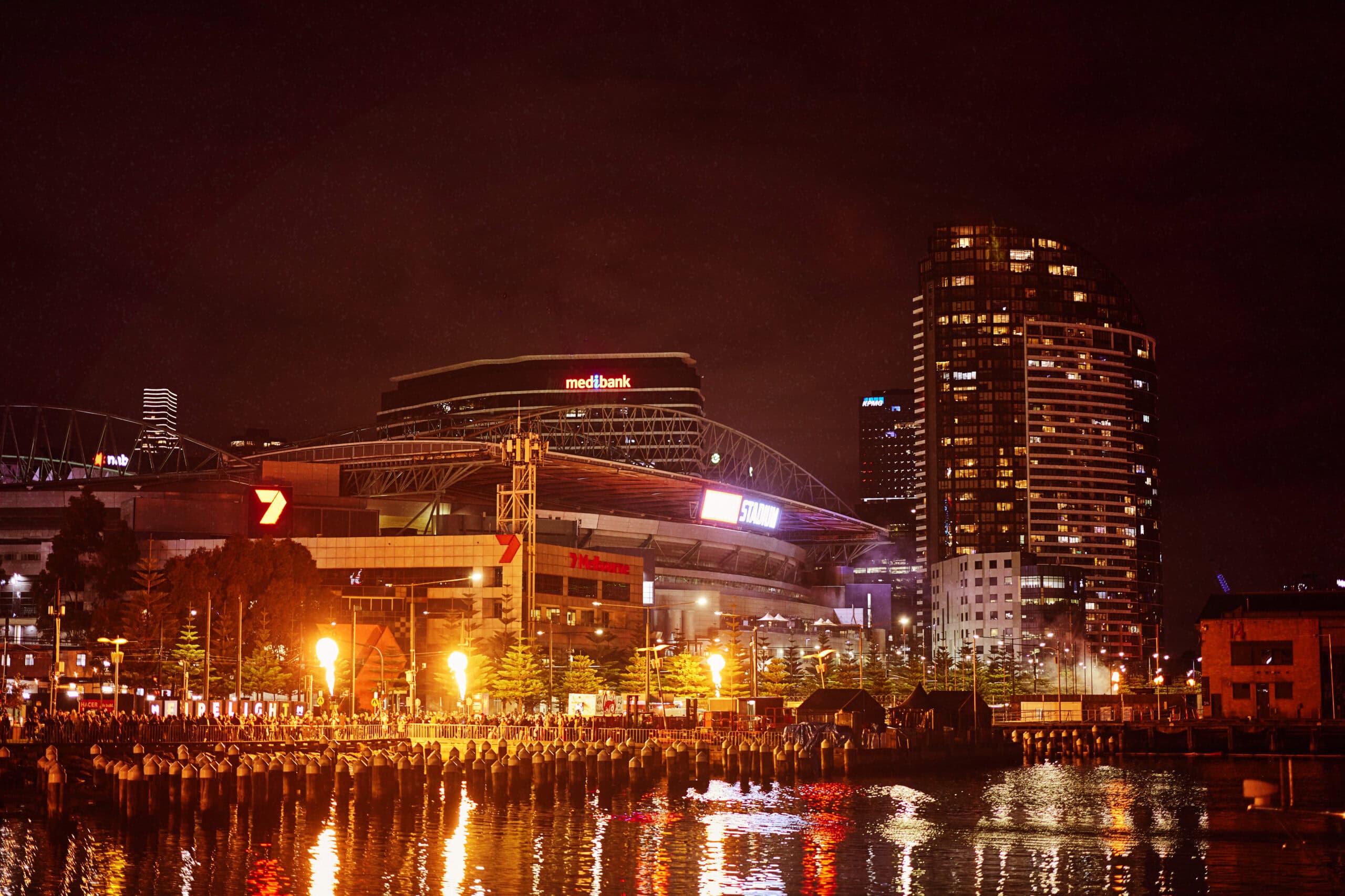 Fire performers, flame installations and crowds at Firelight Festival in Docklands, Melbourne.