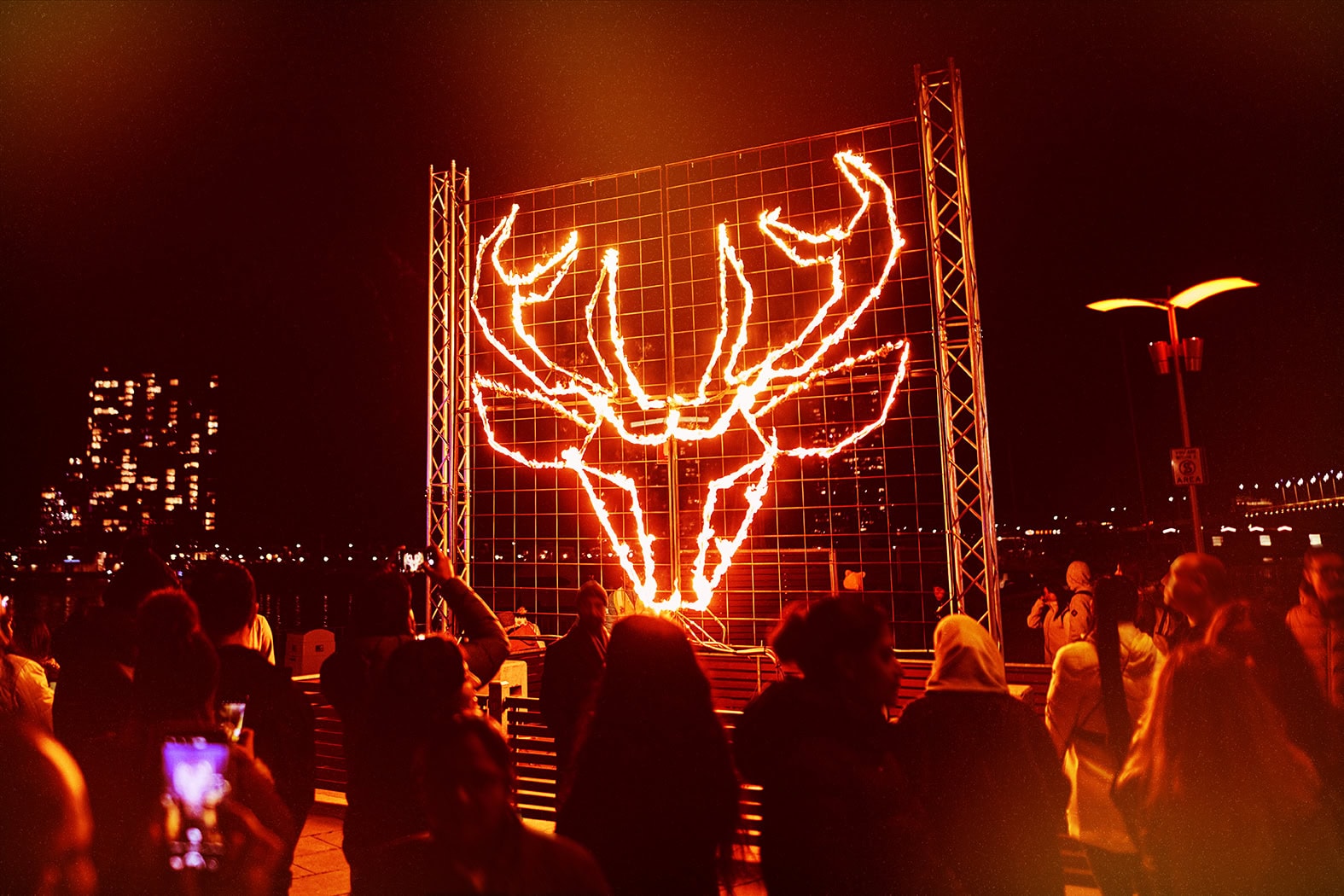Fire performers, flame installations and crowds at Firelight Festival in Docklands, Melbourne.