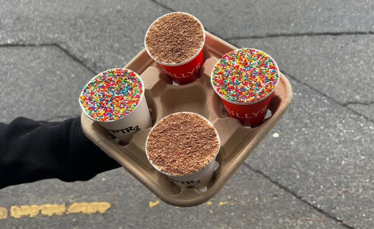 Four cups of Dot Cake held in a cardboard tray — two topped with colourful hundreds-and-thousands sprinkles and two with chocolate shavings, from Gilly's Espresso and Chapter 3 in Adelaide.