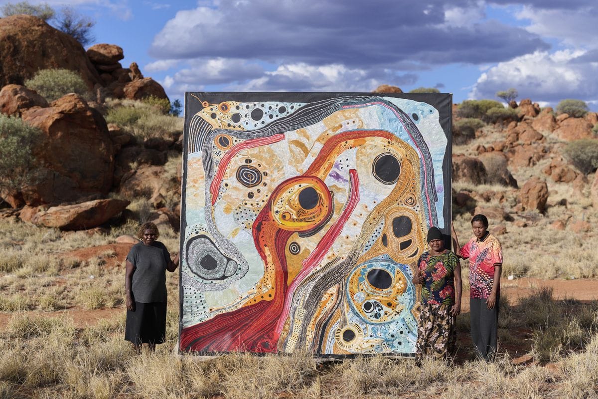 Pitjantjatjara artists with collaborative painting Kapi Water 2022 Mimili Maku Arts APY Art Centre Collective South Australia