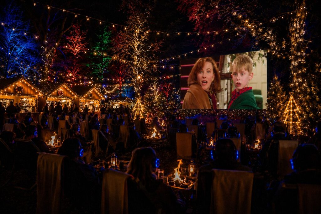 Render of Christmas village with fairy lights firepit cinema and market chalets Christmas in July Festival Canberra