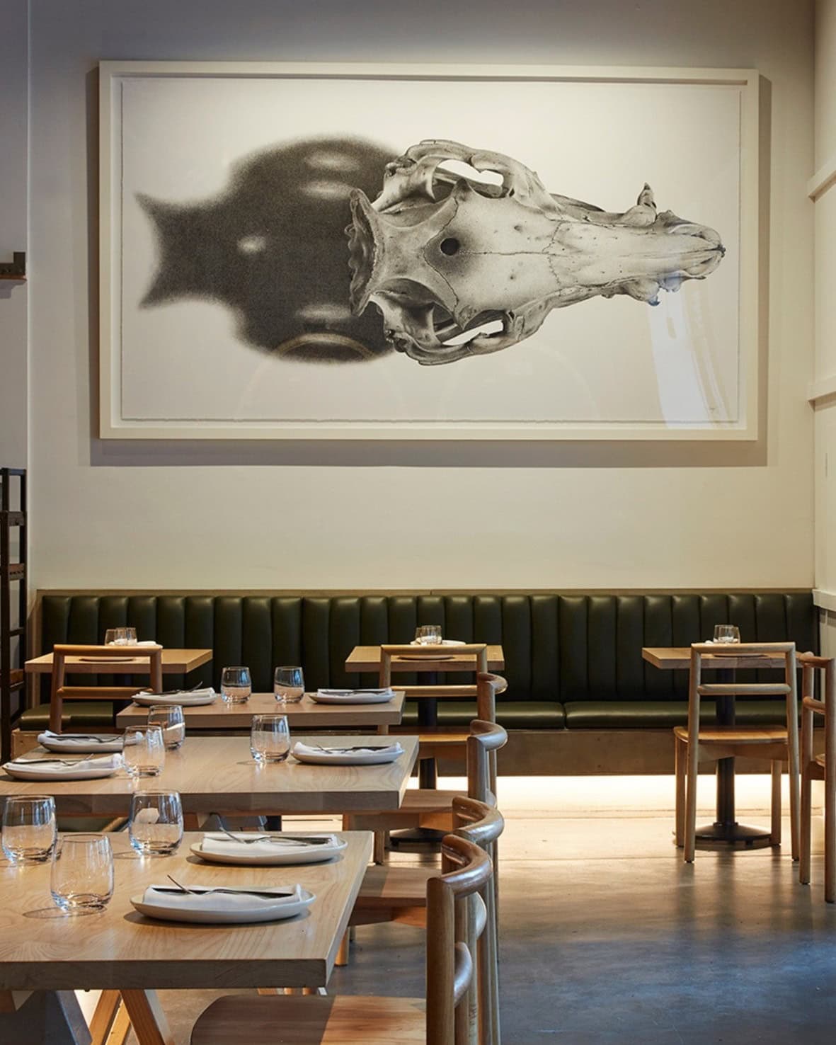 The laidback dining room at Nomad featuring a large black and white print.