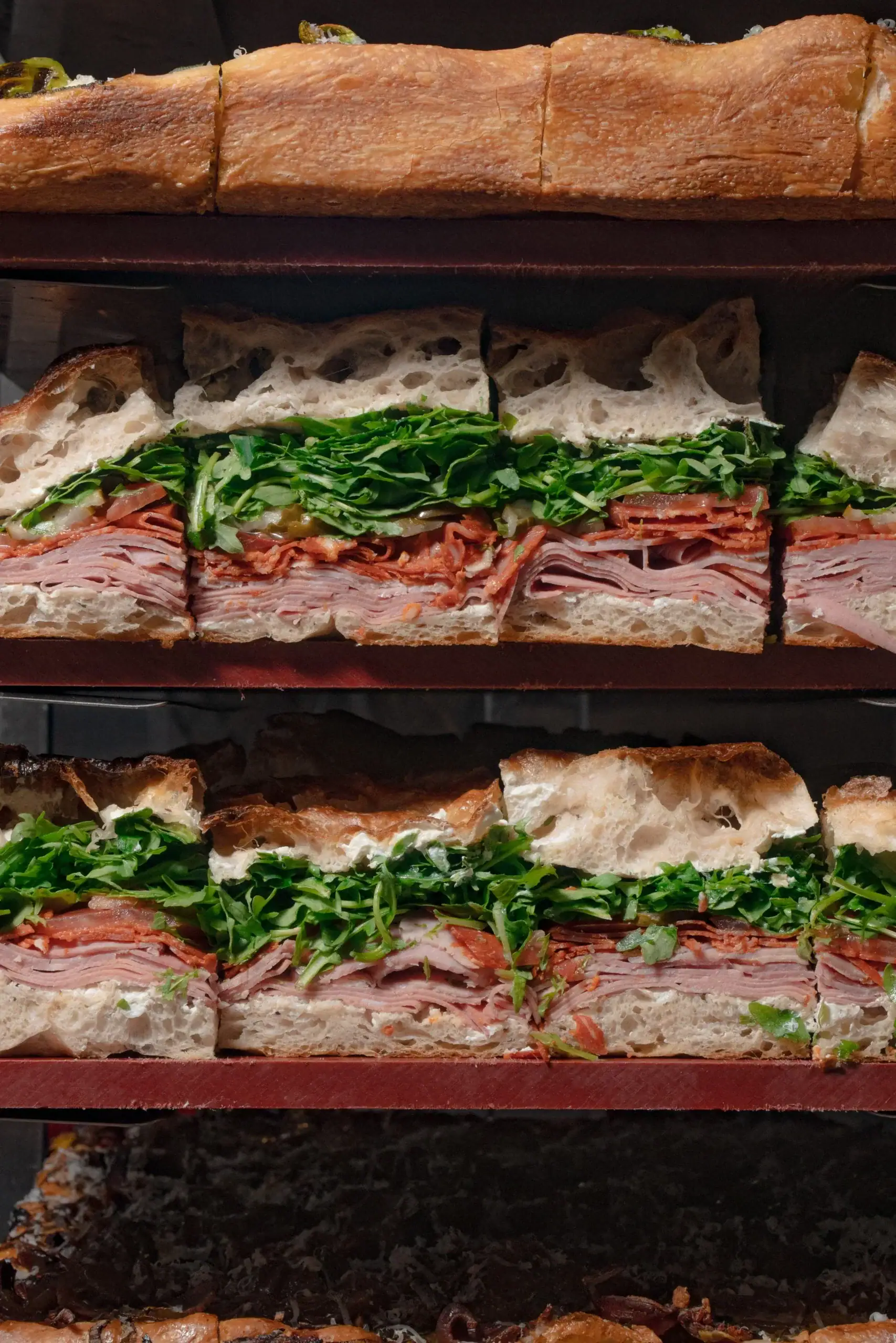 Norma's Deli sandwiches sliced on rack with ham, salami and rocket at Manly Sydney