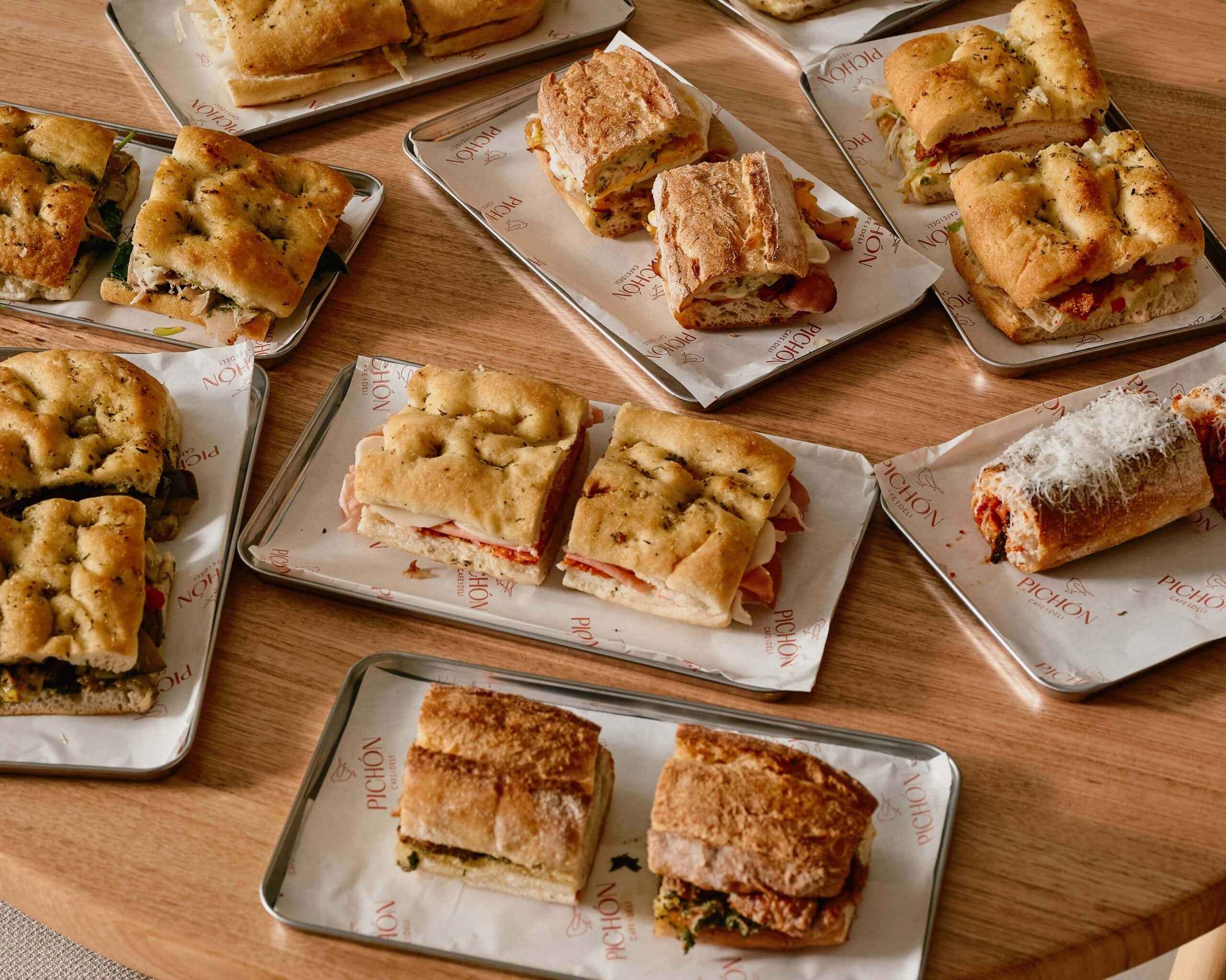 Selection of panini and focaccia sandwiches on branded trays Pichon Norwest Sydney
