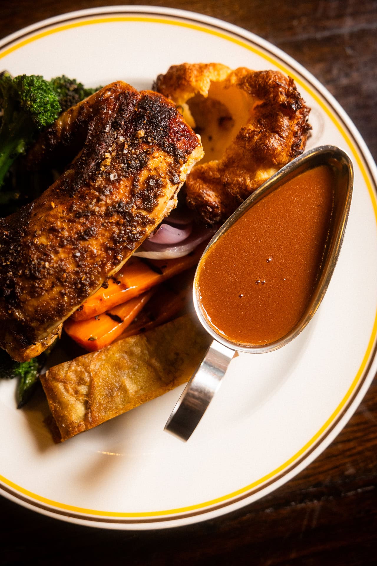 Roast chicken with crispy skin Yorkshire pudding roasted carrots broccoli and rich gravy at The Bat and Ball Hotel Redfern Sydney