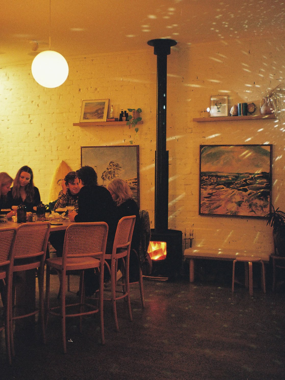 Dining area with fireplace at Nauti Buoy in Adelaide.