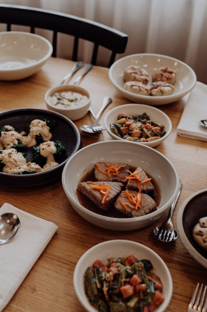 Japanese-inspired dishes served at The Agrarian Kitchen cooking class, with dumplings, vegetables and bowls on the table.