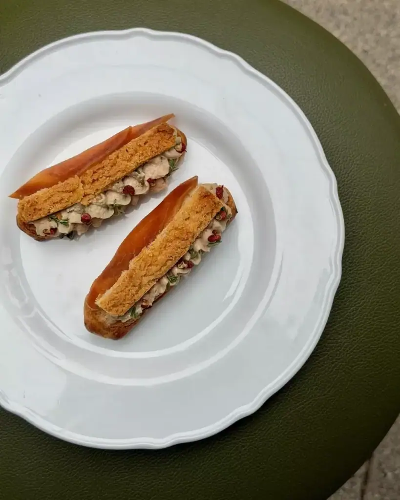 Duck liver parfait eclair, spiced plum, szechuan peppercorn from Bistro Massilia.
