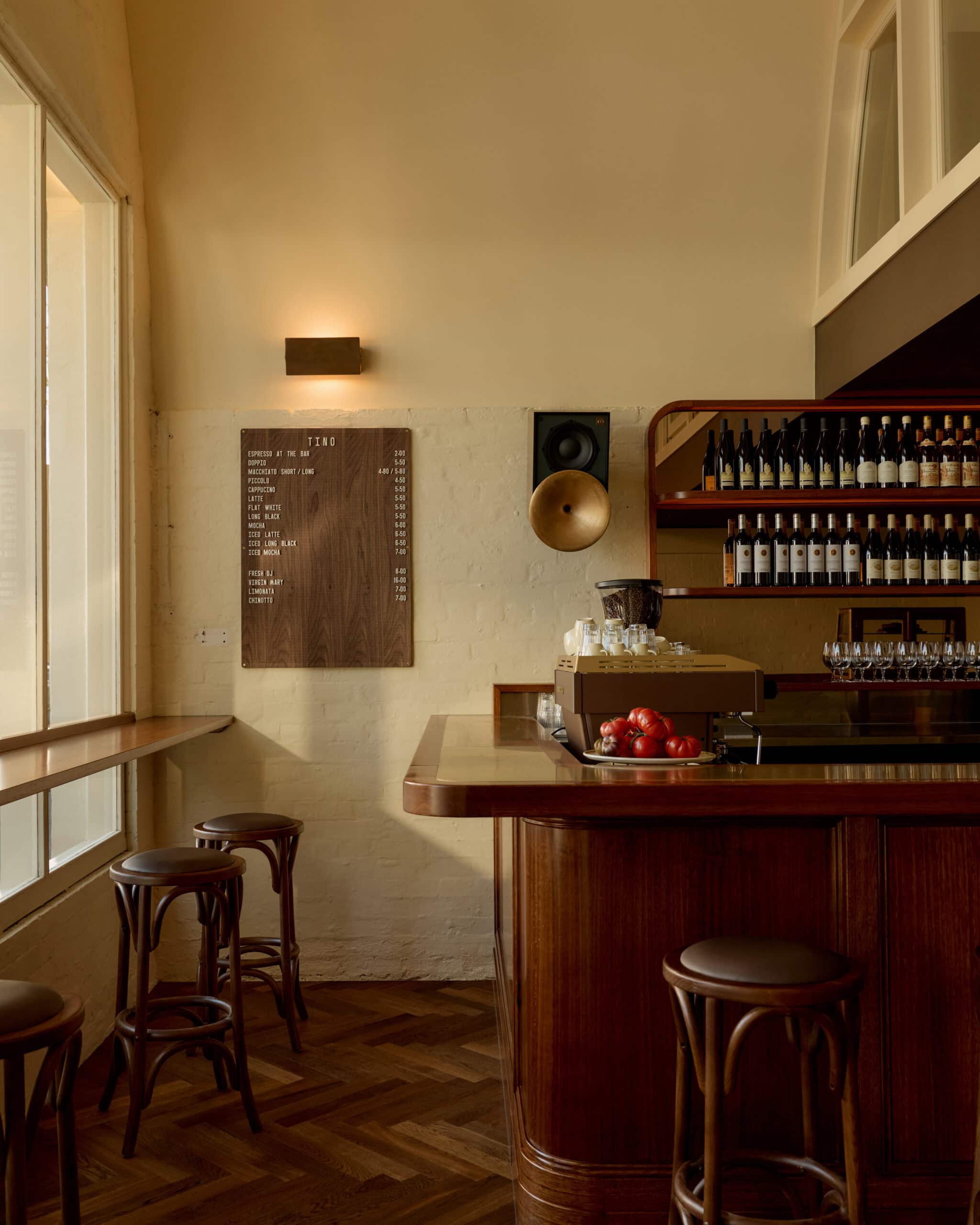 The Tasmanian oak bar lined with wine bottles at Bistro Tino in Brisbane.