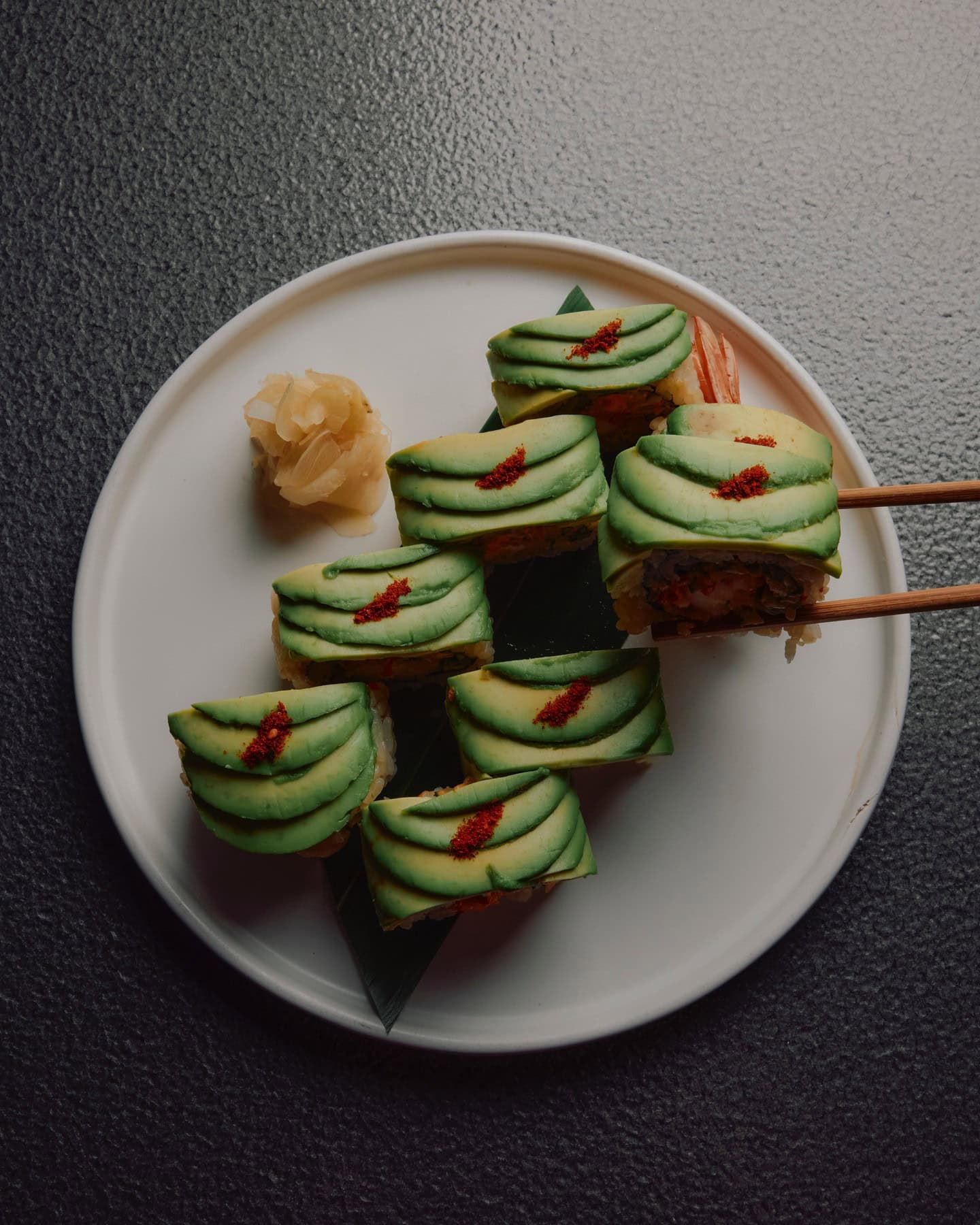 8 pieces of dainty avocado sushi atop a circle plate at Honto in Brisbane.