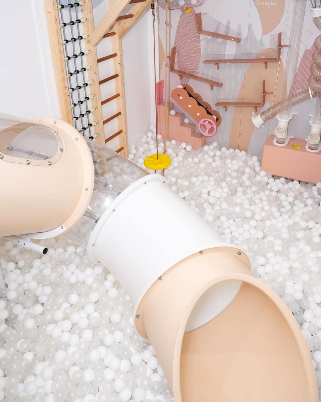 A tunnel on top of a ball pit in the pastel indoor play centre play maison in brisbane