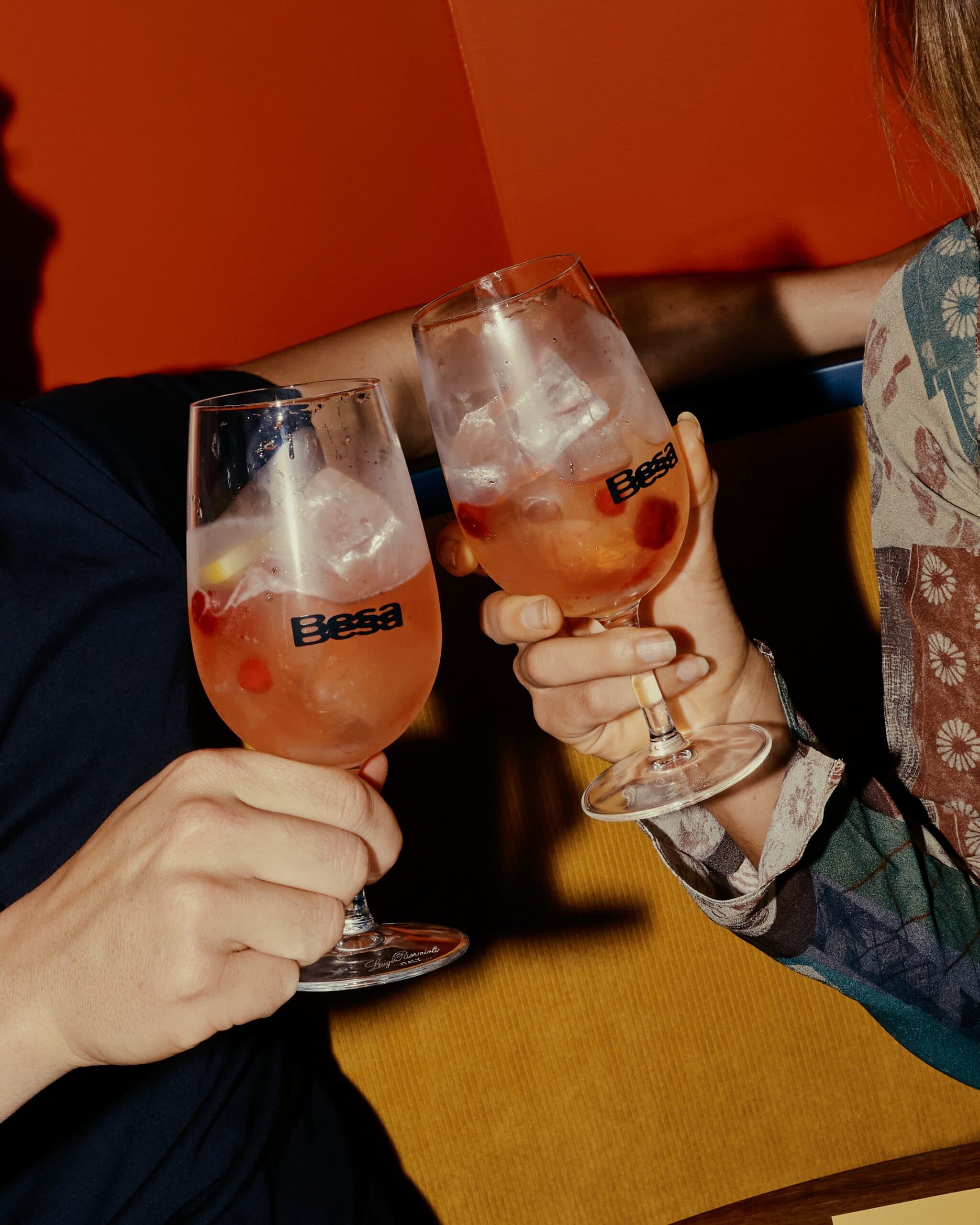 Besa rose sangria glasses being clinked by two people during aperitivo hour Bondi Sydney