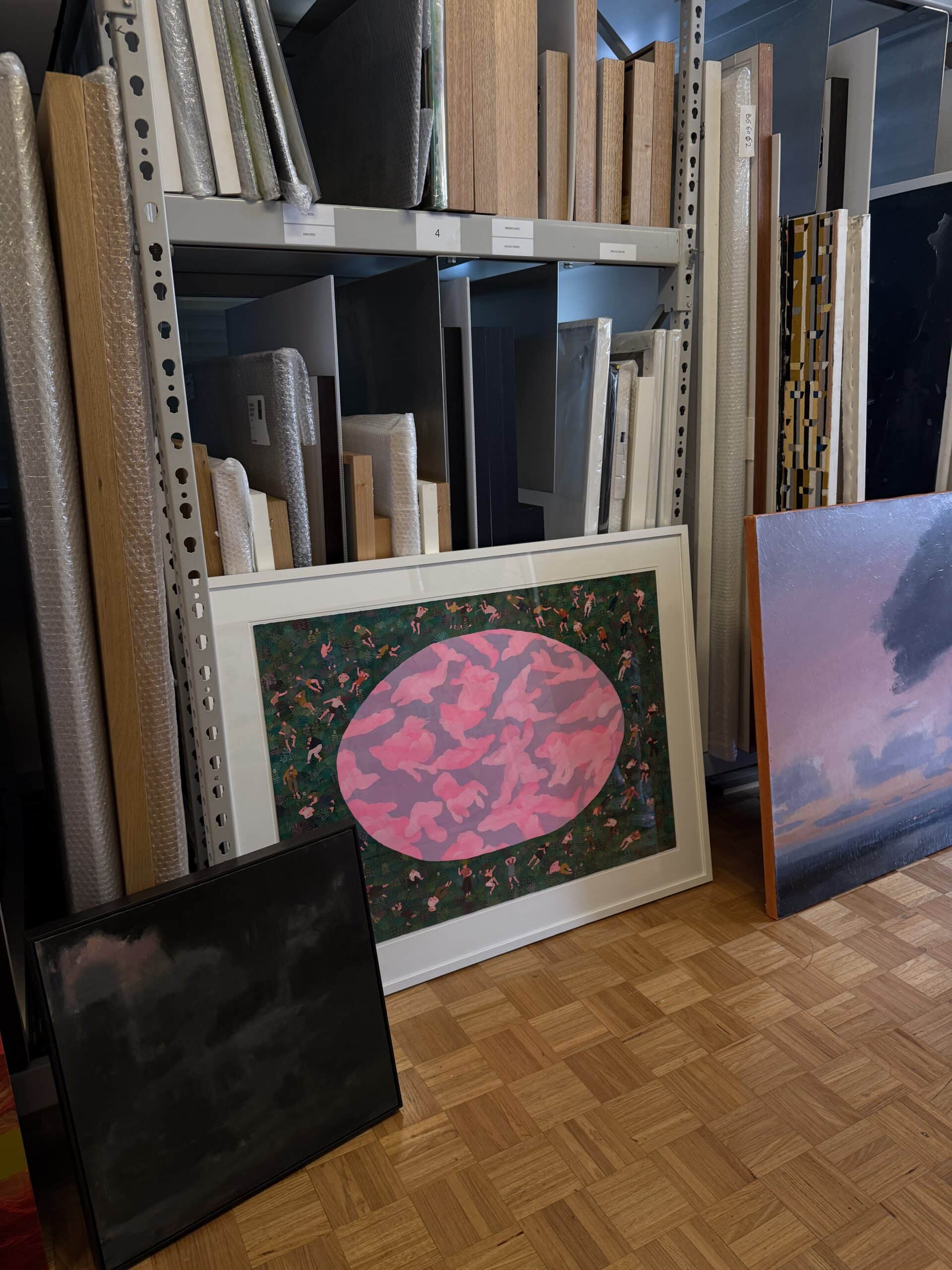 Artworks leaning against storage racks in the Bett Gallery.