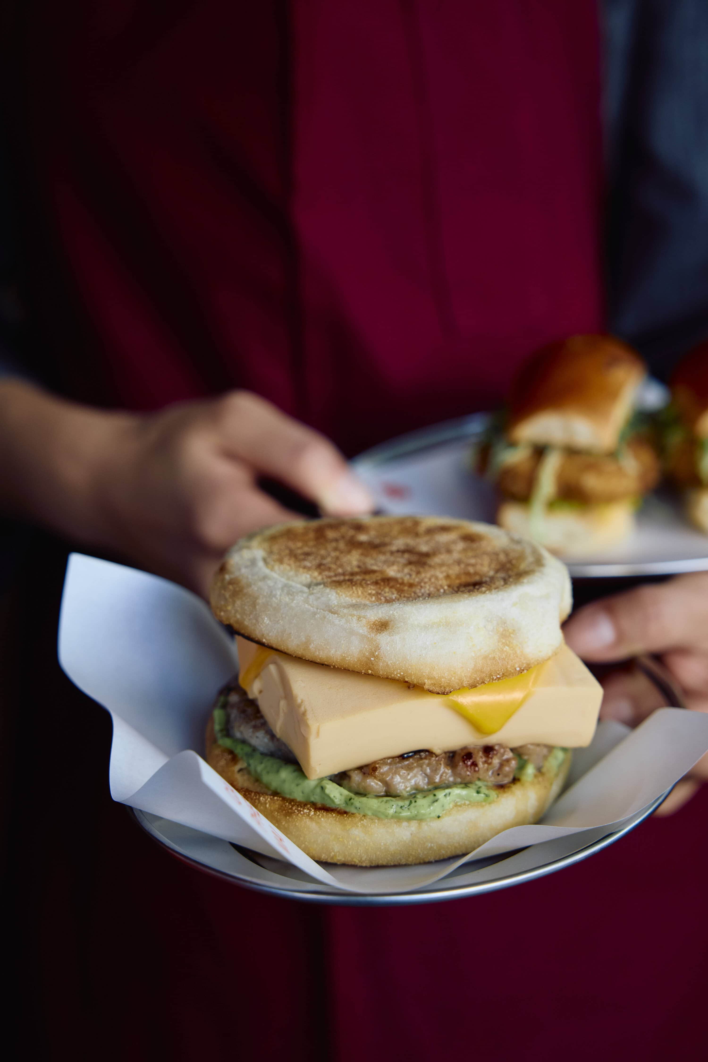 Breakfast banh mi on English muffin with cheese and avocado served on tray Ca Phe Mai Double Bay Sydney