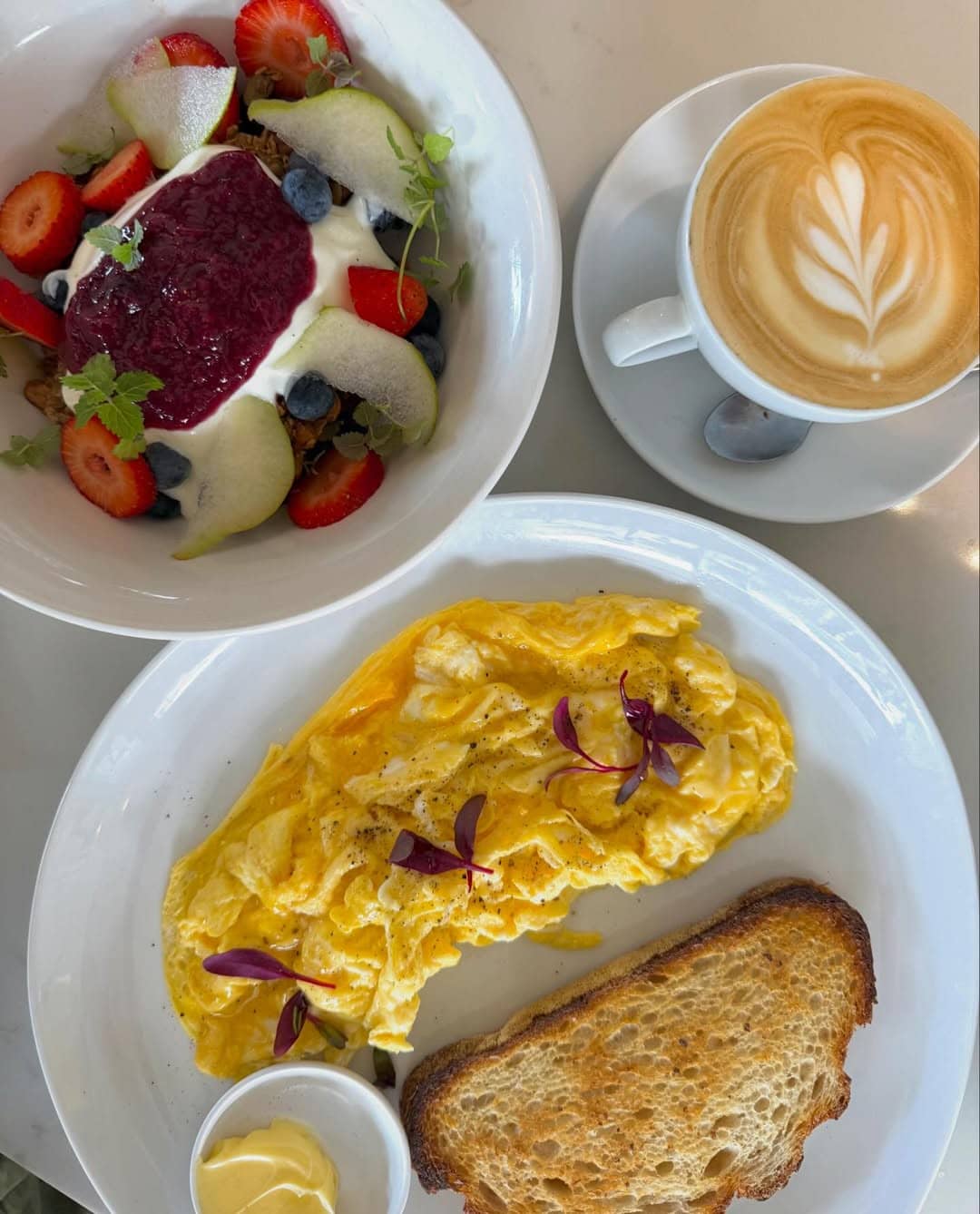 A plate of scrambled eggs and a coffee at favolso espresso bar and deli in bronte.