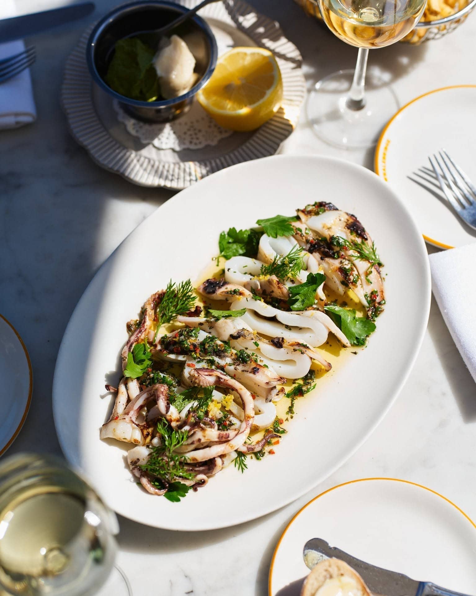 A large platter of calamari with soft filtered light shining on it at whalebridge in Circular Quay.