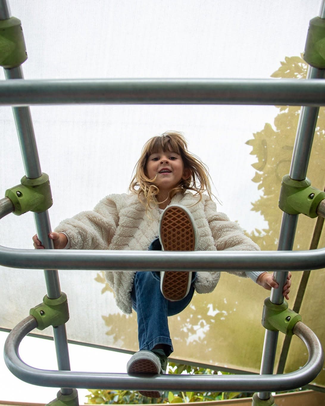 A picture from below of a child crossing the bridge at lyne park in rose bay.