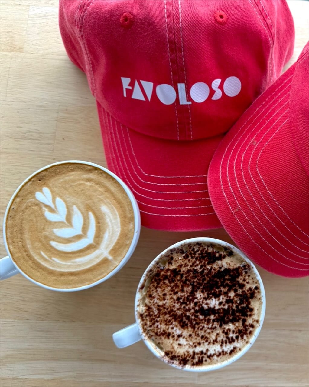 Two coffees and a branded red hat at favolso espresso bar and deli in bronte.