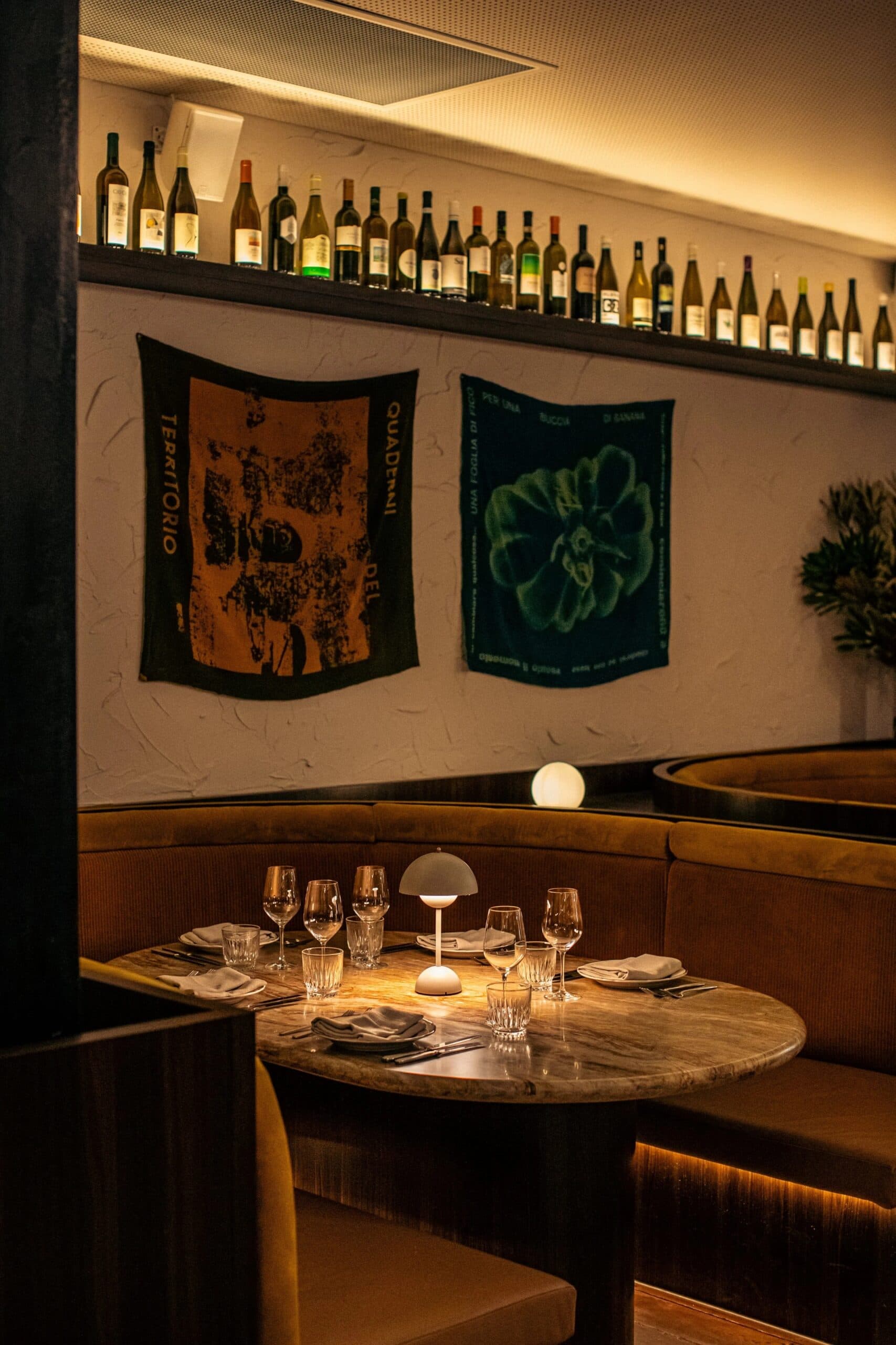 Moody booth seating with marble table and wine wall at Palazzo Salato Sydney CBD