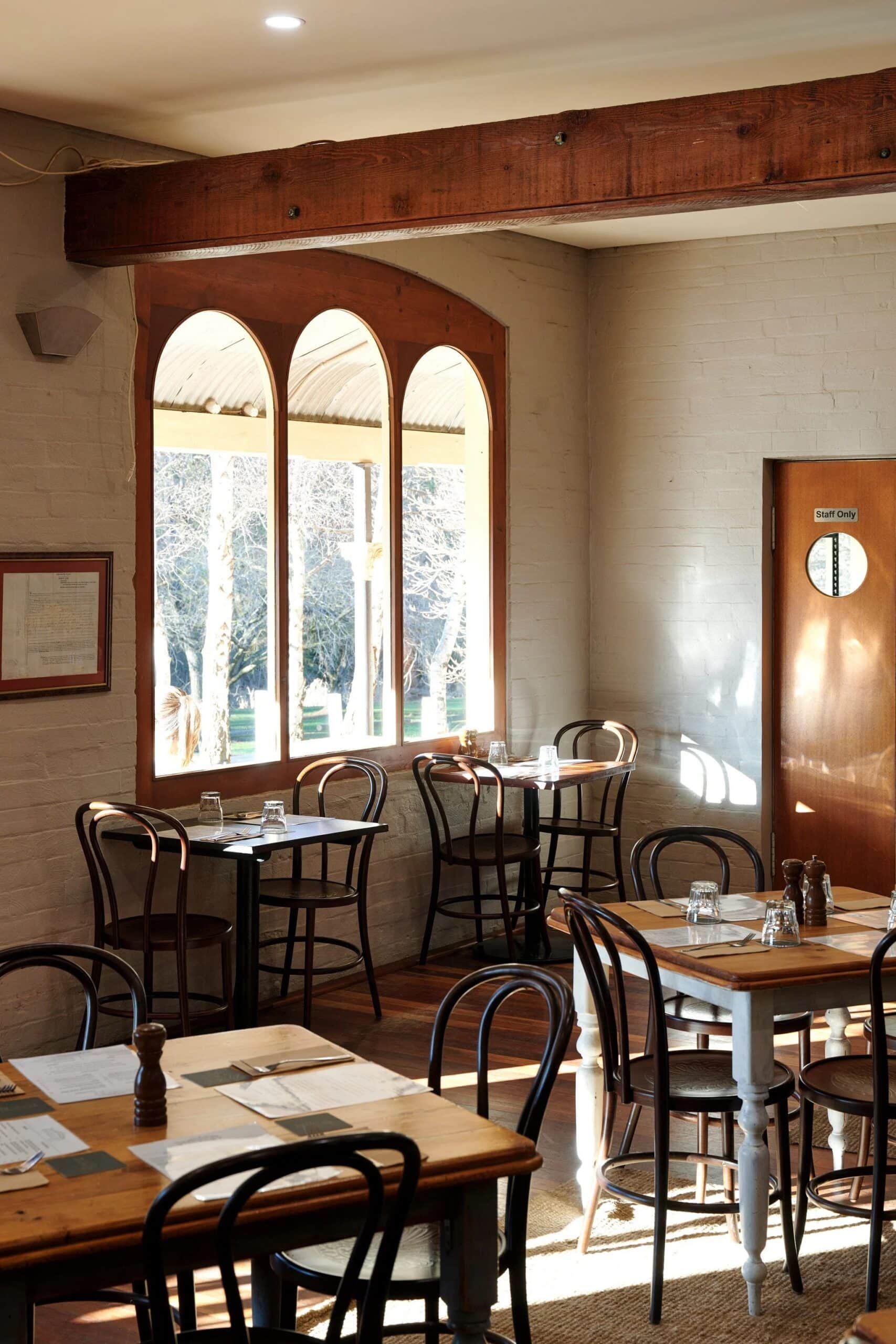 Dining room interior with arched windows and bentwood chairs at The Rockley Pub Rockley NSW