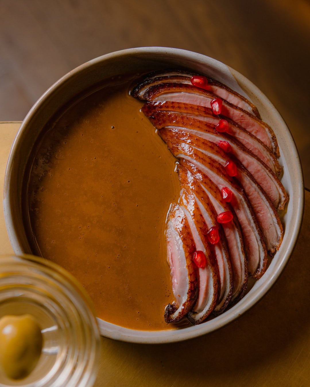 A delicately plated duck dish, spread out in a fan, atop a plate at Aalia in Sydney.