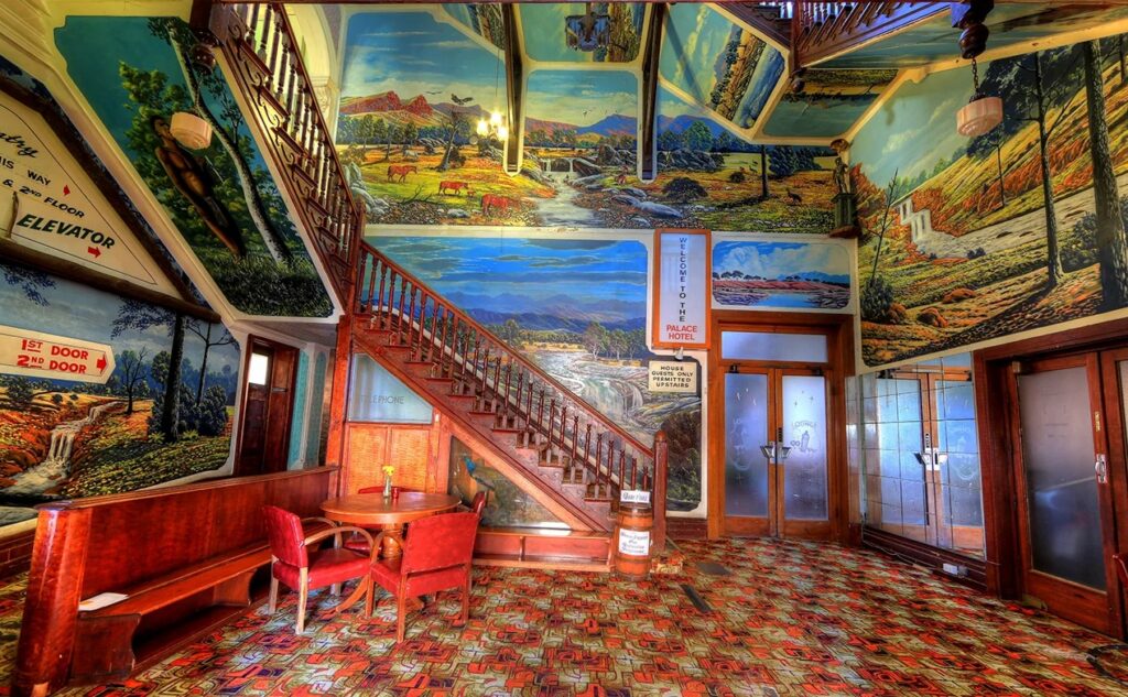 Foyer staircase with Indigenous landscape murals by Gordon Waye at Palace Hotel Broken Hill NSW