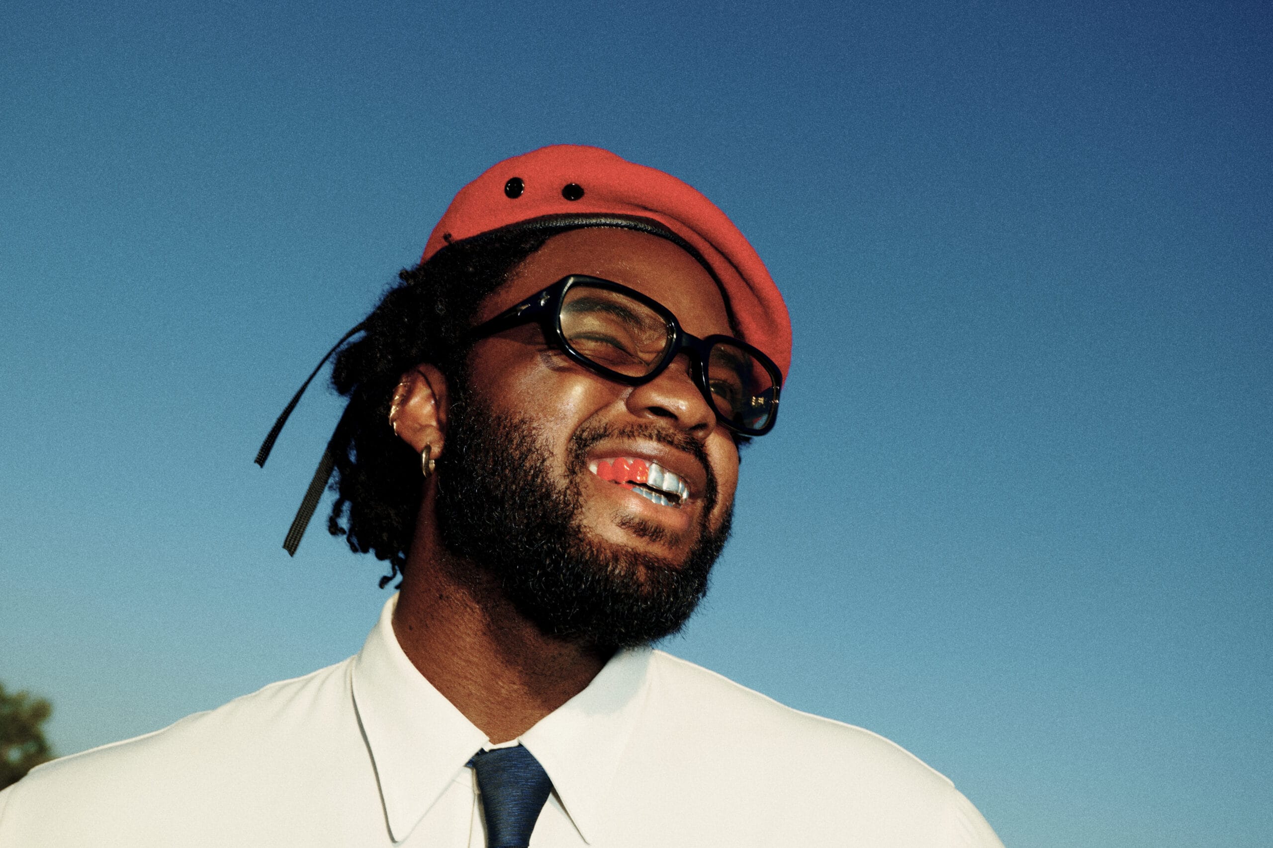 Genesis Owusu artist press shot red beret sunglasses gold grills Spotify Turn Up Aus Bat and Ball Hotel Redfern Sydney