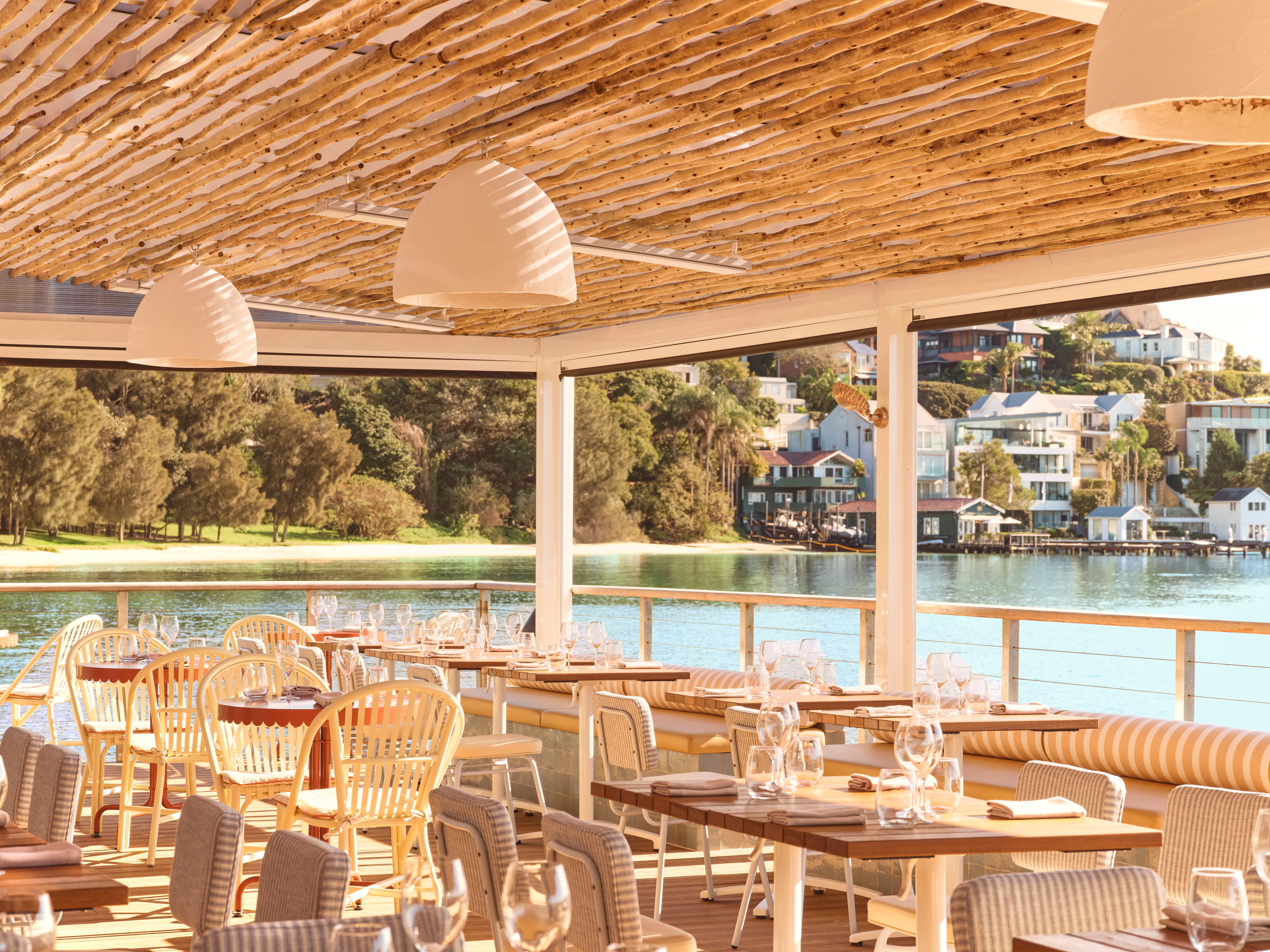 Waterfront terrace dining area overlooking the harbour at Ripples Rose Bay