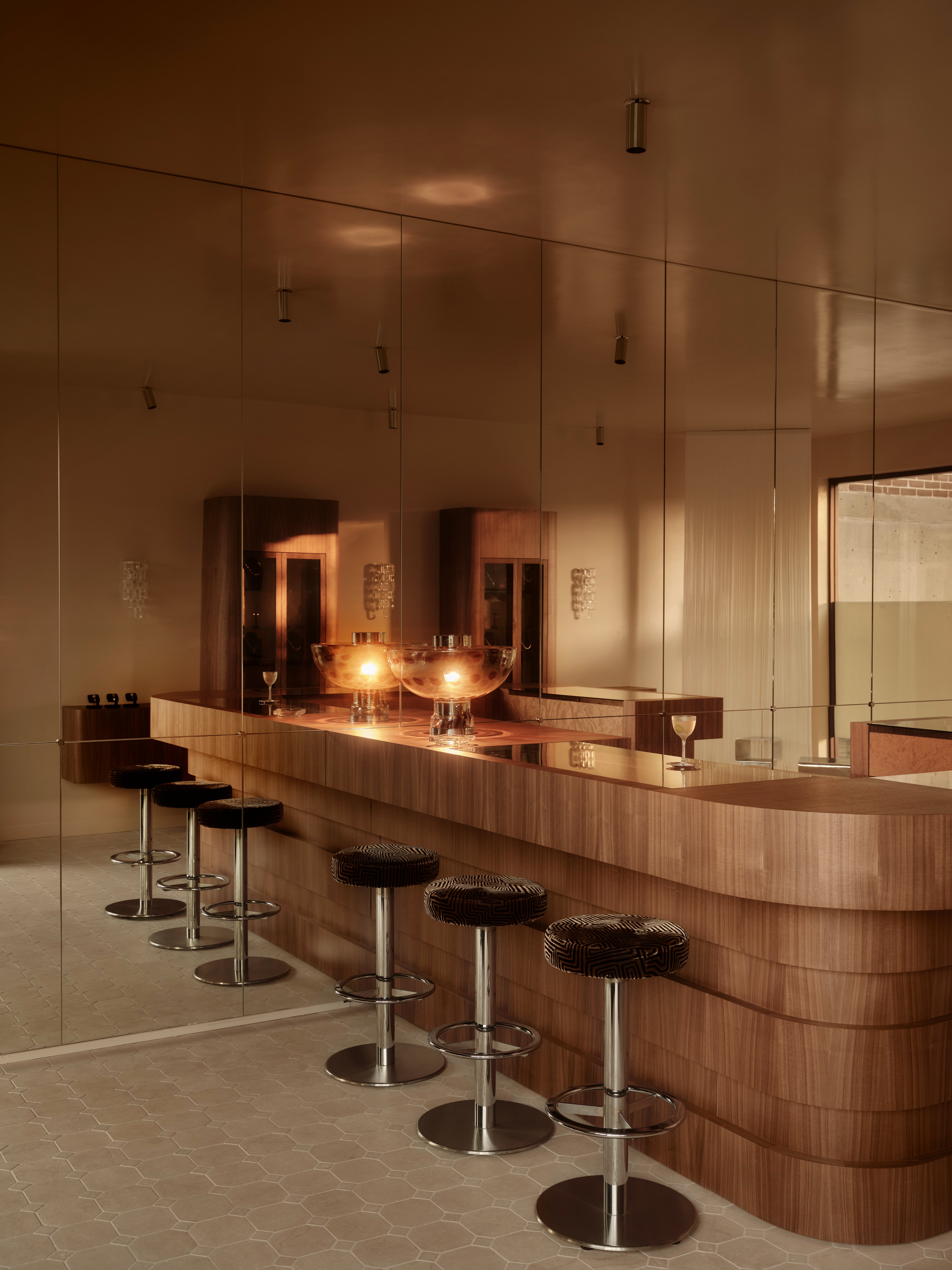 Curved walnut jewellery bar with upholstered bar stools and mirror walls Love Isabelle Manly Sydney