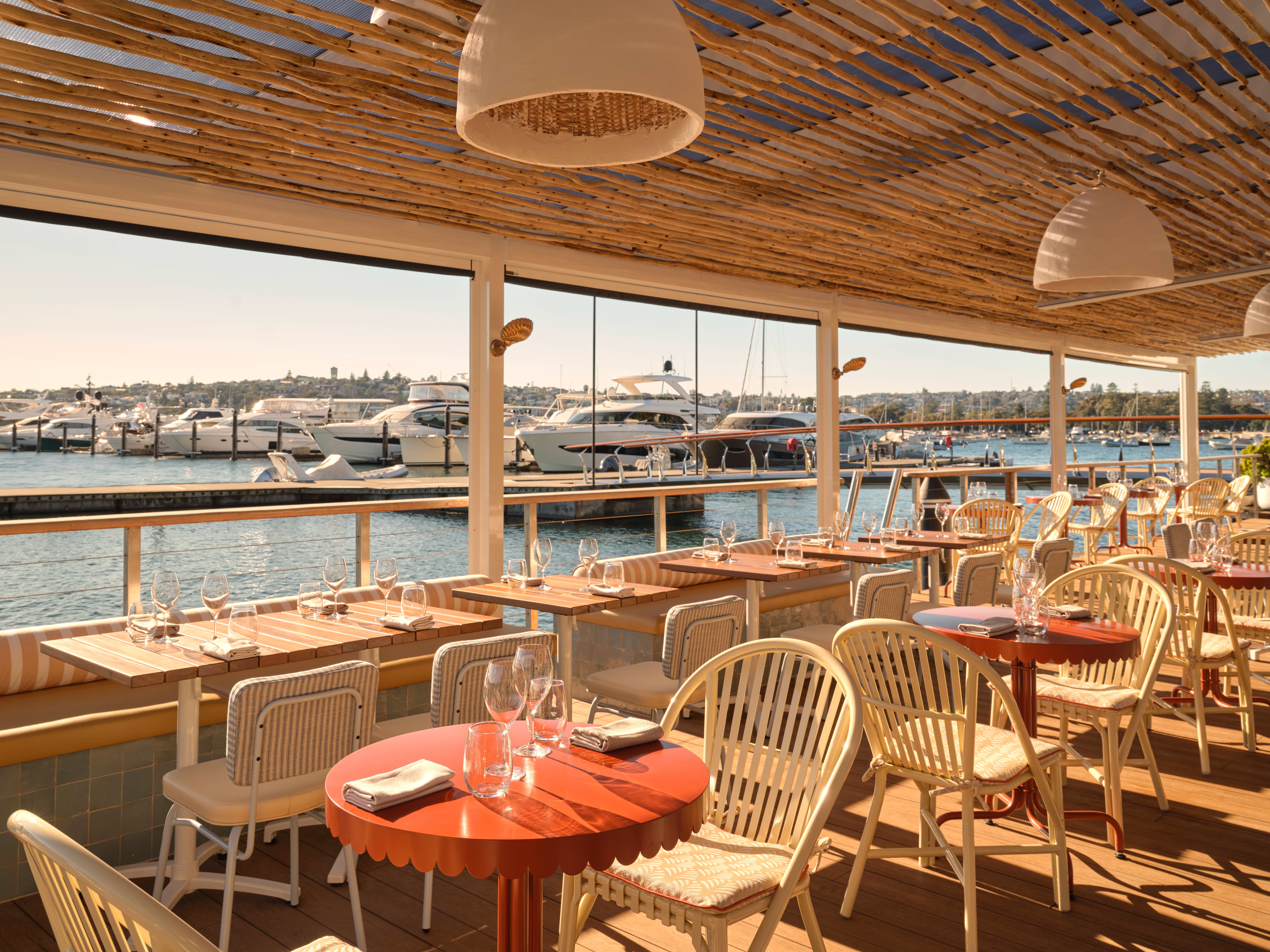 Marina view terrace dining area with boats at Ripples Rose Bay