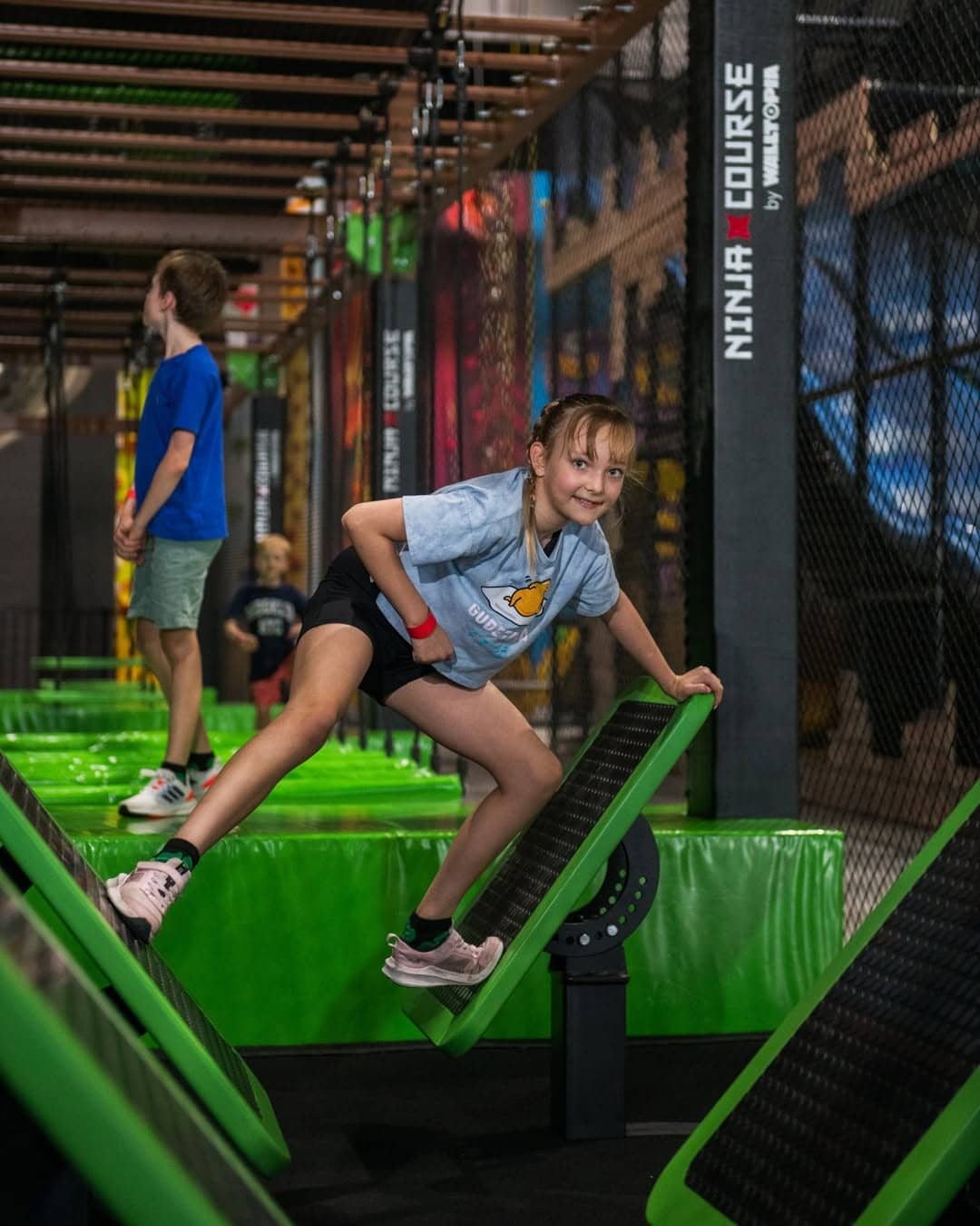 A child playing on the ninja course at the jungle adventure playground in Brisbane