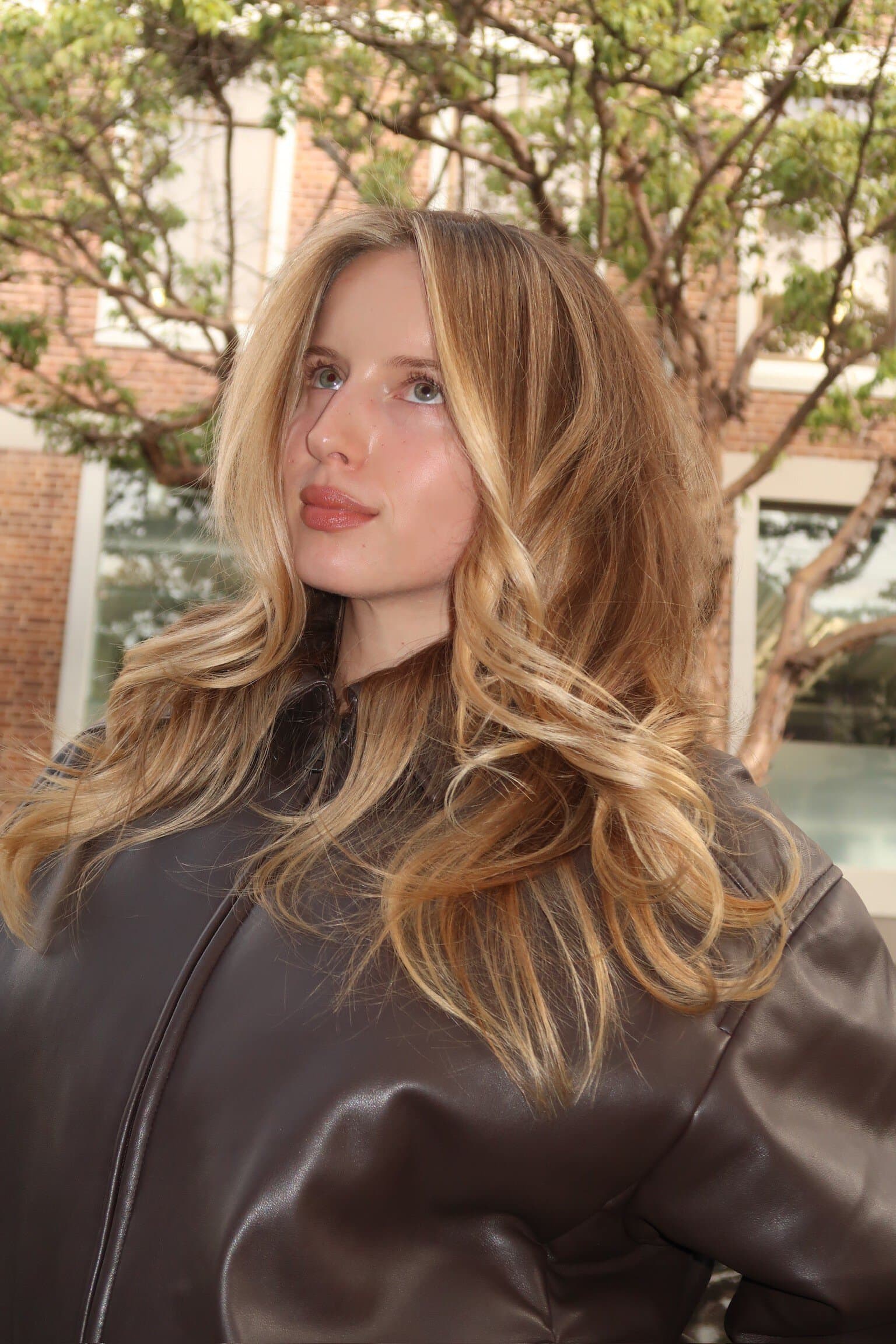 QUE Colour client with balayage blonde highlights and long wavy blow dry Darlinghurst Sydney