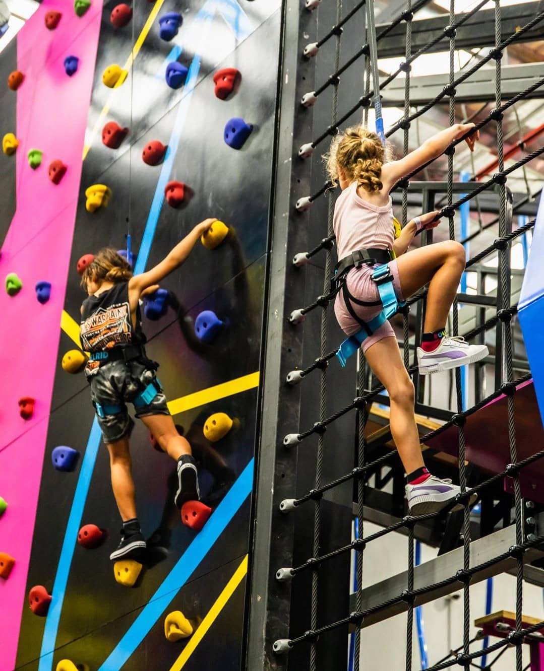 Two kids climbing a wall at bounce inc