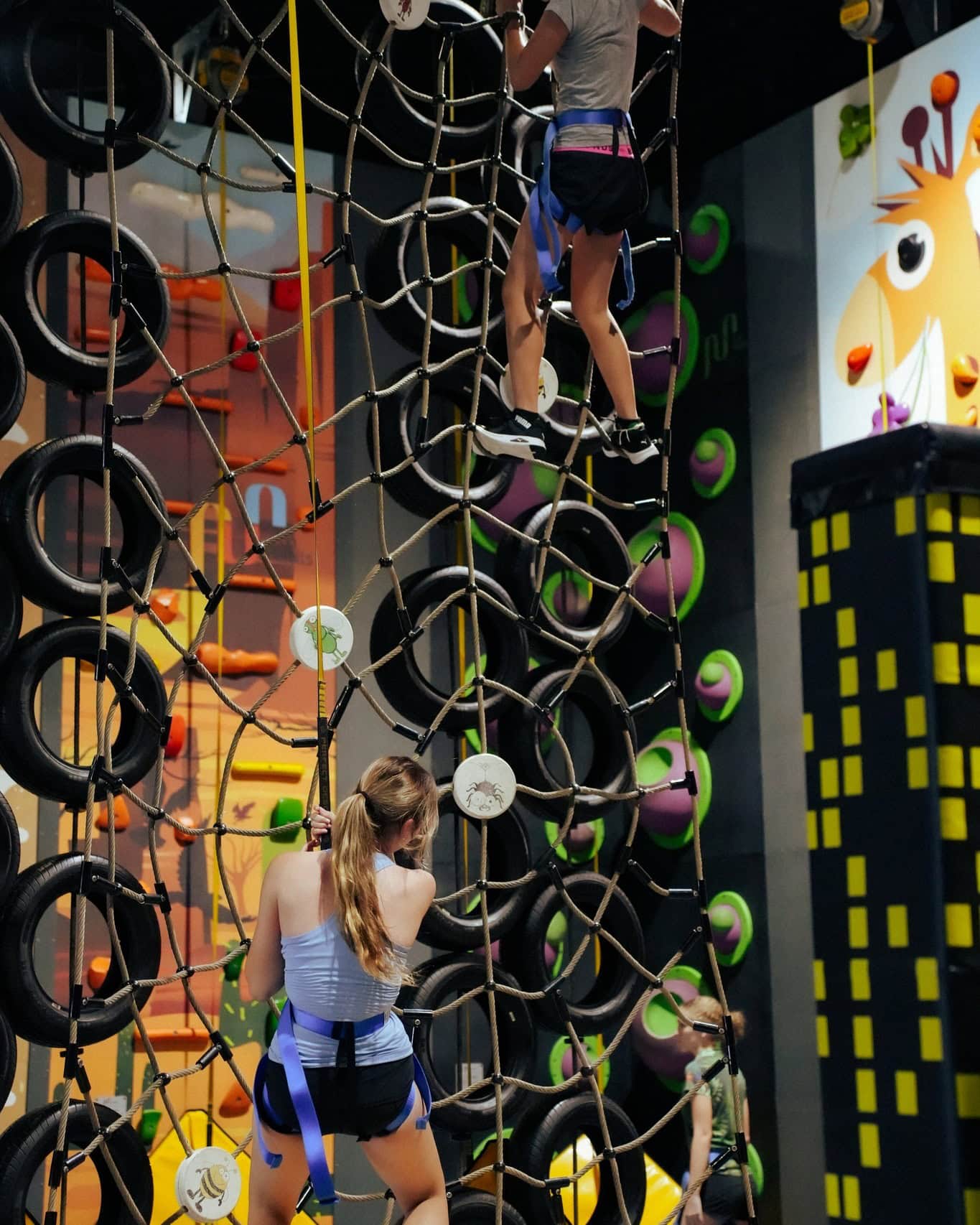 Two children climbing a rope course at jungle adventure playground in brisbane