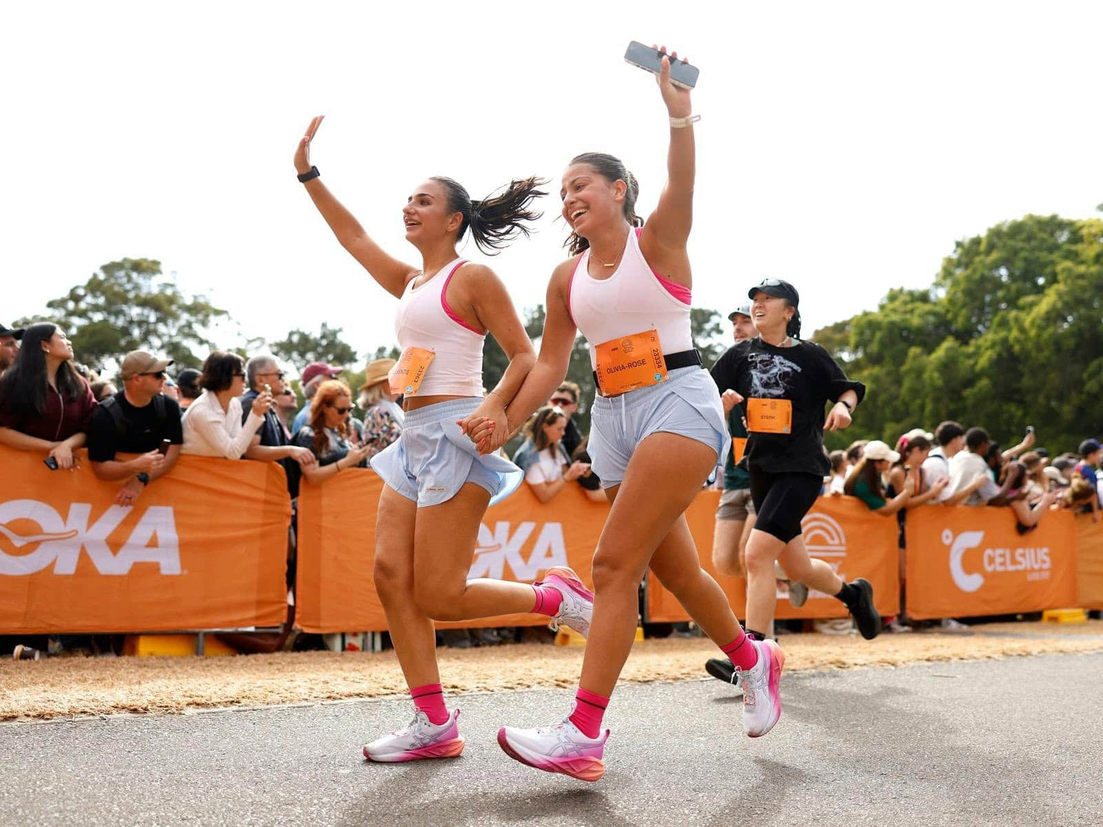 Runners celebrating at finish line of HOKA Runaway Sydney Half Marathon