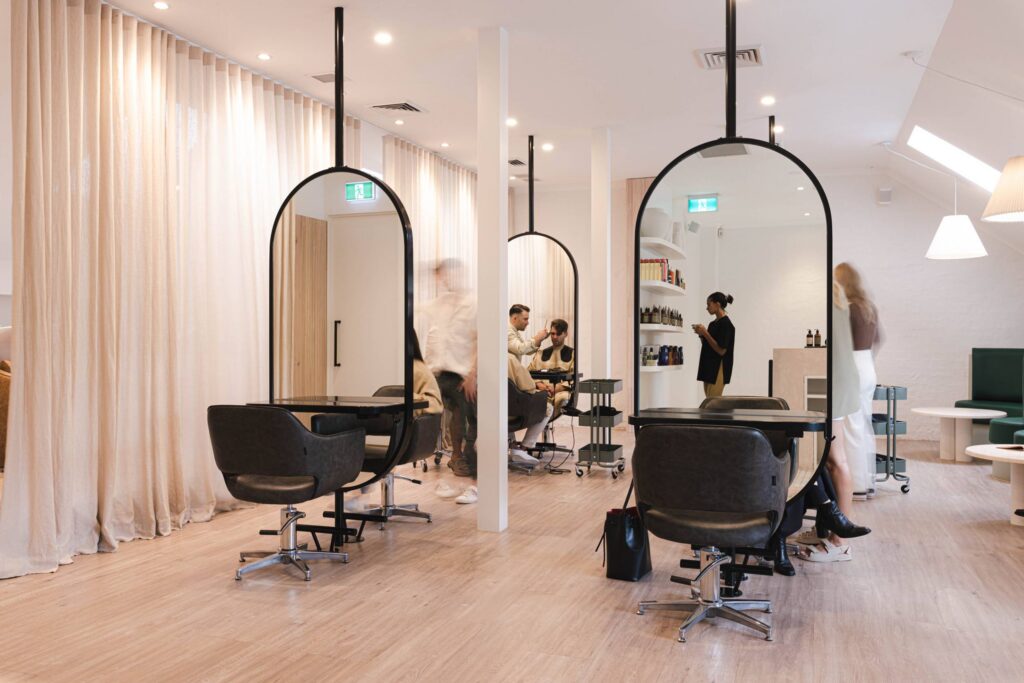 Salon interior with arched hanging mirrors styling chairs and linen curtains Polly and Stone Sydney