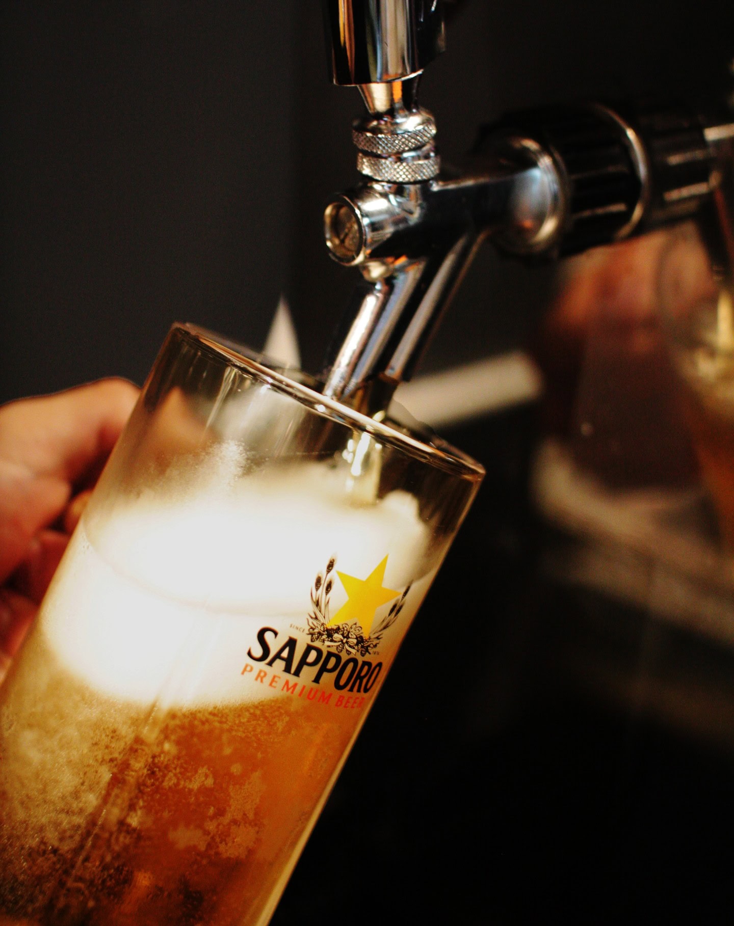 A fresh Sapporo beer being poured from the tap at Haruya Izakaya in Graceville.