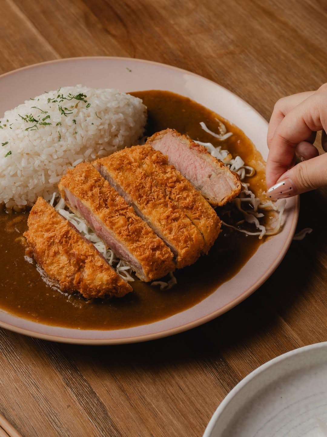 Senkatsu sliced pork katsu curry with steamed rice on pink plate Liverpool Street Sydney CBD