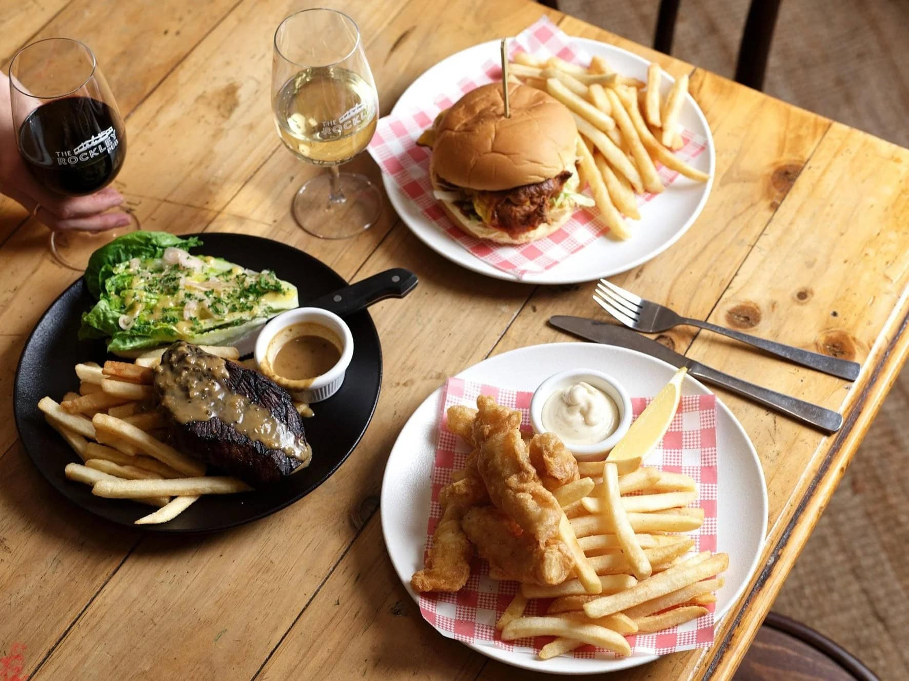 Steak, burger and fries, and fish and chips on table at The Rockley Pub Rockley NSW