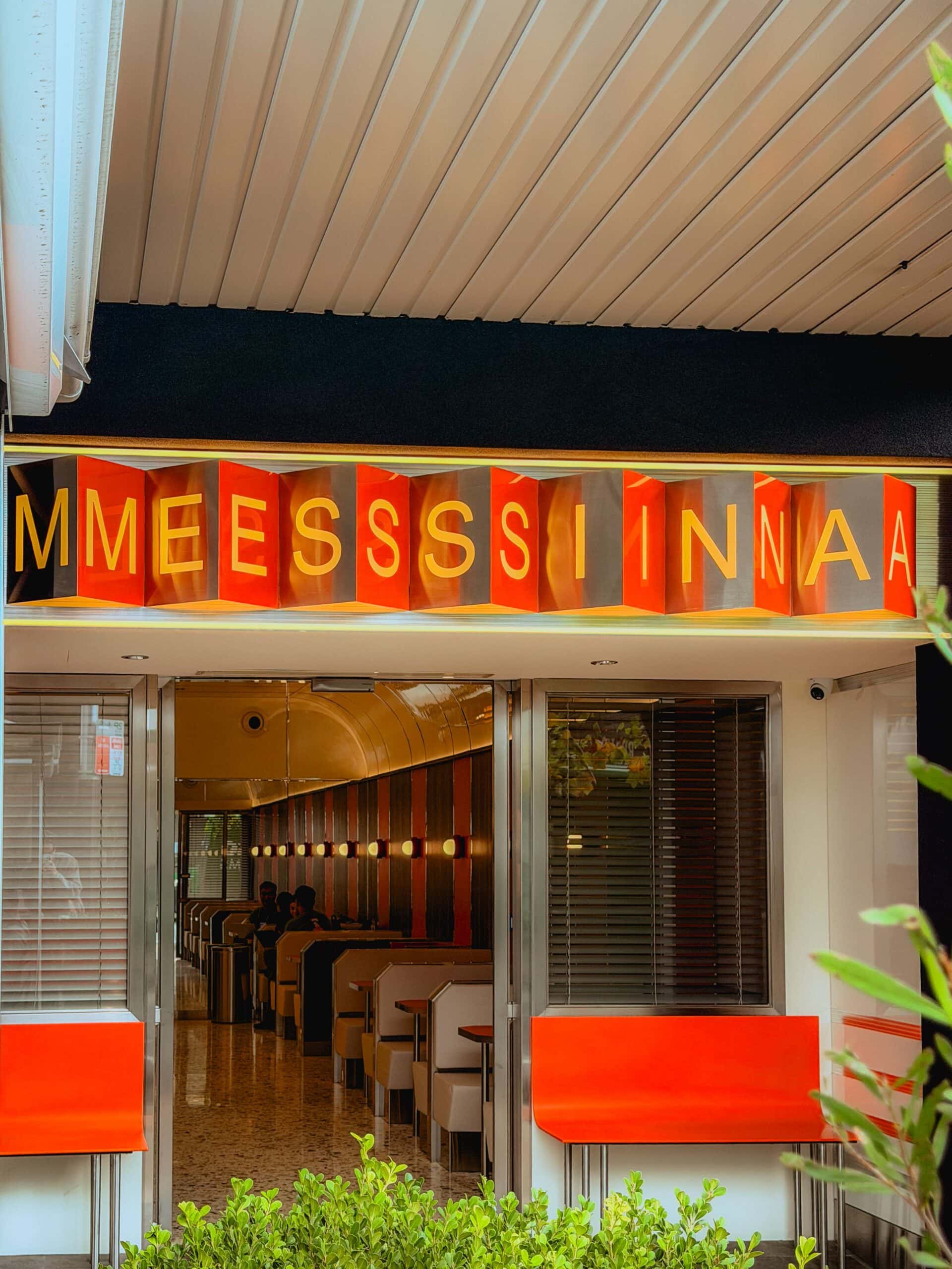 Store entrance with illuminated orange Messina signage and red outdoor seating Crows Nest Sydney